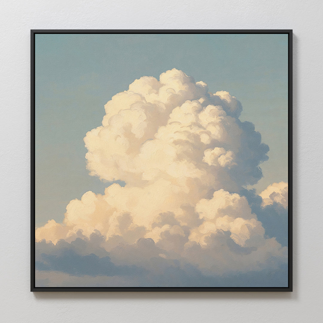 Soft Skies Rising Canvas Art features a large, fluffy white cloud against a blue sky, framed and displayed on a light wall with sunlight creating soft shadows for a serene, sky-inspired atmosphere.