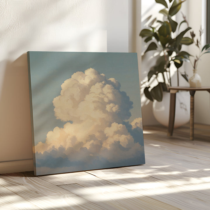 The Soft Skies Rising Canvas Art, featuring fluffy white clouds on a blue sky, rests on a sunlit wooden floor beside a plant and small table in a bright, cozy room.