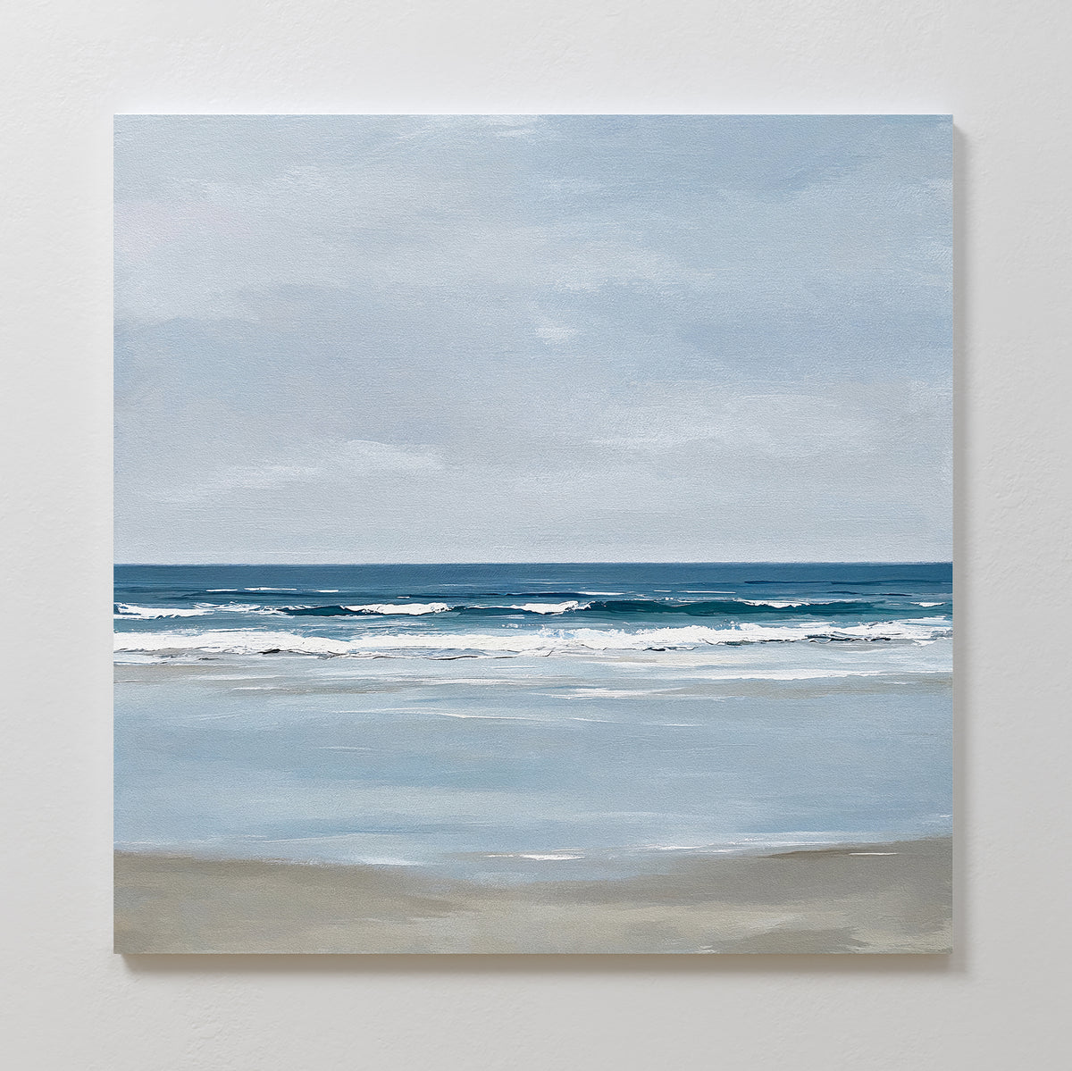 Soft Tide Canvas Art captures a tranquil beach scene with gentle waves and a cloudy sky in soft blue, gray, and beige tones—ideal canvas art for adding coastal decor to your space.