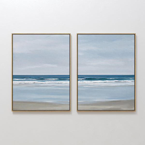 The Soft Tide Set of 2 features framed paintings with serene beach scenes—soft blue sky, gentle waves, and wet sand—creating calm, minimalist wall art, perfect for coastal decor or bringing tranquility to any bedroom.