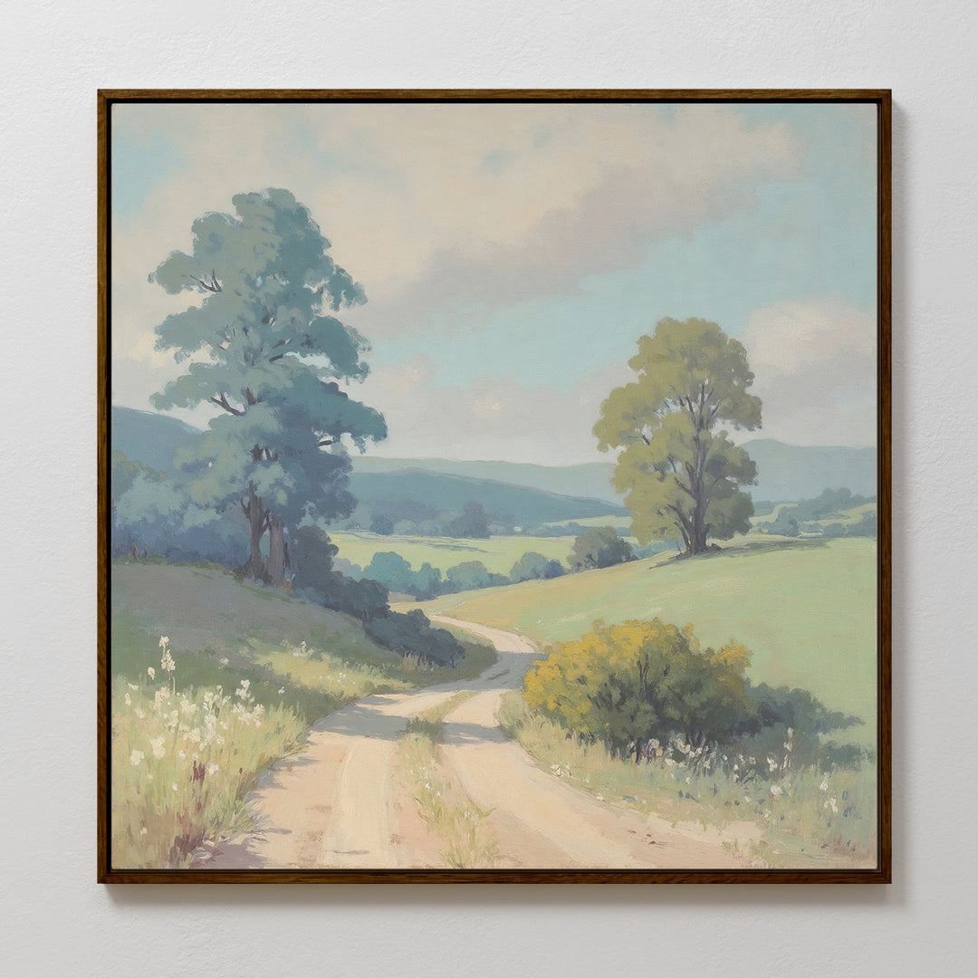 The Summer Dale Canvas Art features a framed countryside landscape of a dirt road winding through grassy hills with wildflowers, tall green trees, and distant blue hills beneath a cloudy sky. Perfect rustic wall decor for any space.