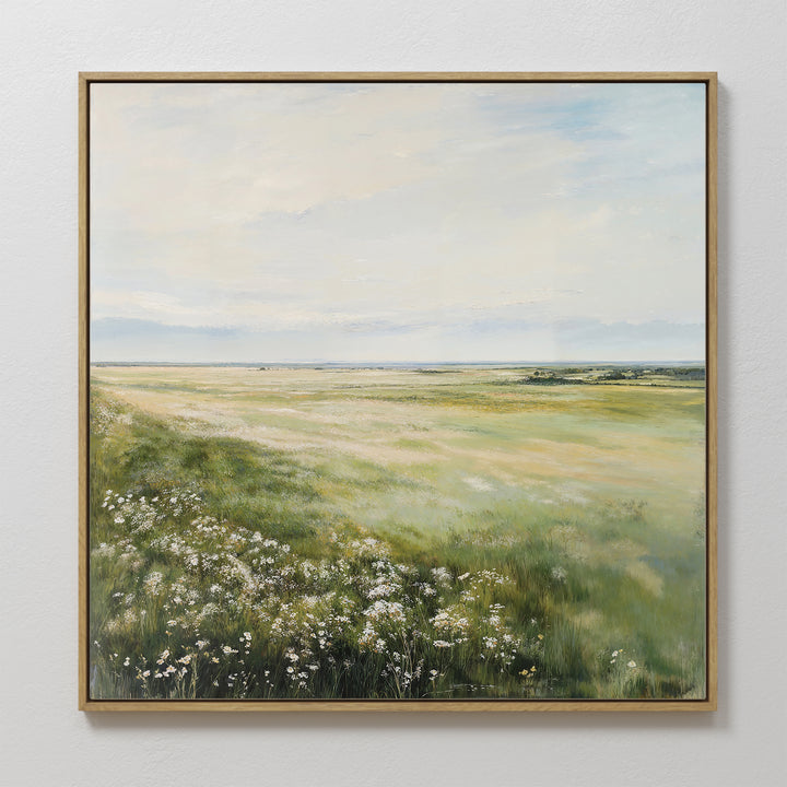 The Summer Meadow Canvas Art features a sunlit meadow with wildflowers and grasses under a pale blue sky, capturing nature’s beauty and adding a serene, spacious feel to your living room décor.