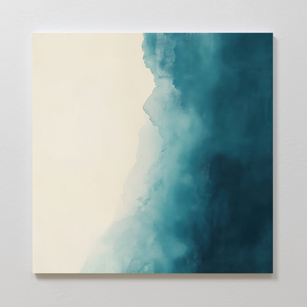 Teal Tide Canvas Art is a square canvas featuring a gradient from soft beige to deep teal blue with a watercolor texture, creating striking modern wall art that stands out against a light grey wall.