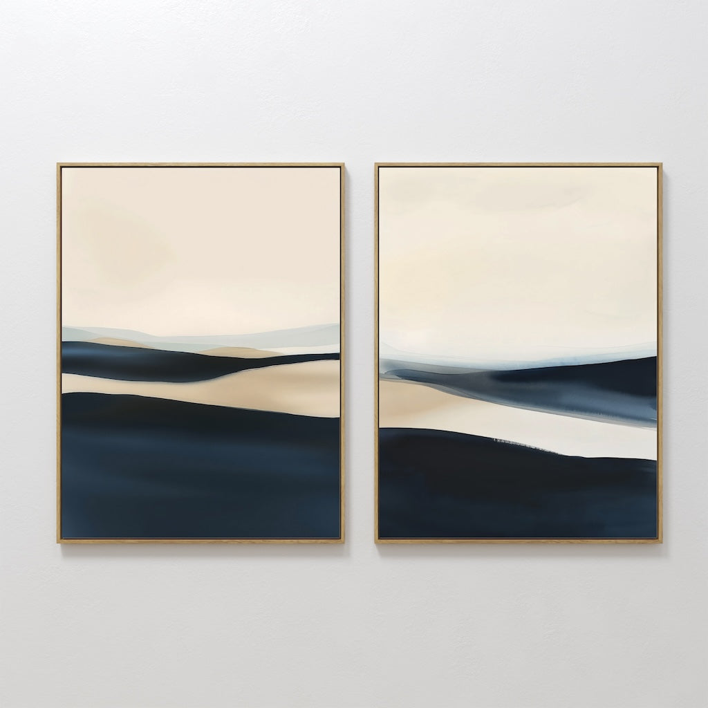 The Twilight Horizons Set of 2 features abstract landscape paintings with layered beige, cream, and deep blue tones. Framed in light wood and ideal for serene decor, they evoke calm hills or distant horizons when hung side by side.