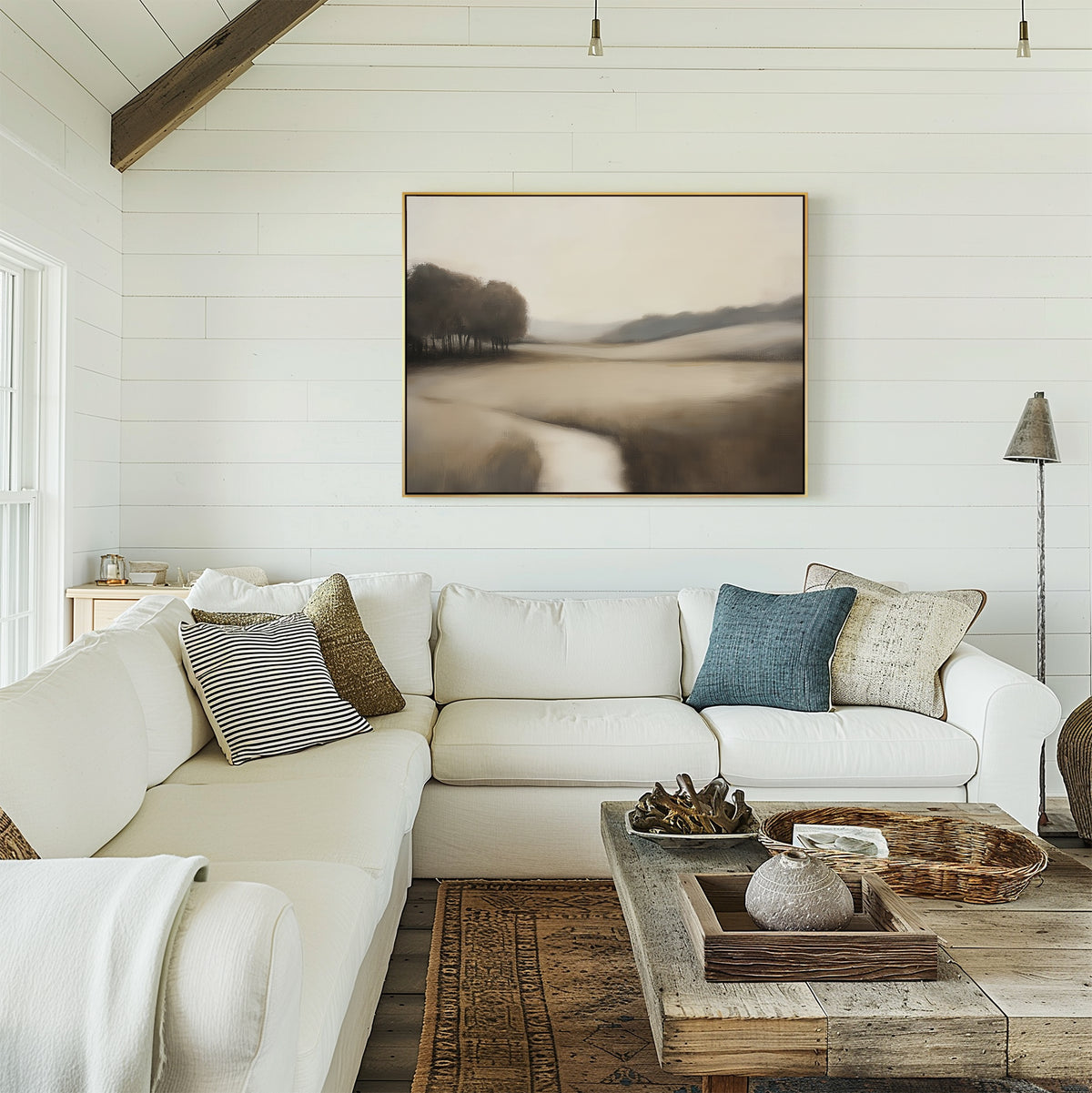 A cozy living room with white shiplap walls, a white sectional sofa with pillows, a rustic wooden coffee table, and the Vintage Horizon Canvas Art – Horizontal in neutral tones hanging above the couch.