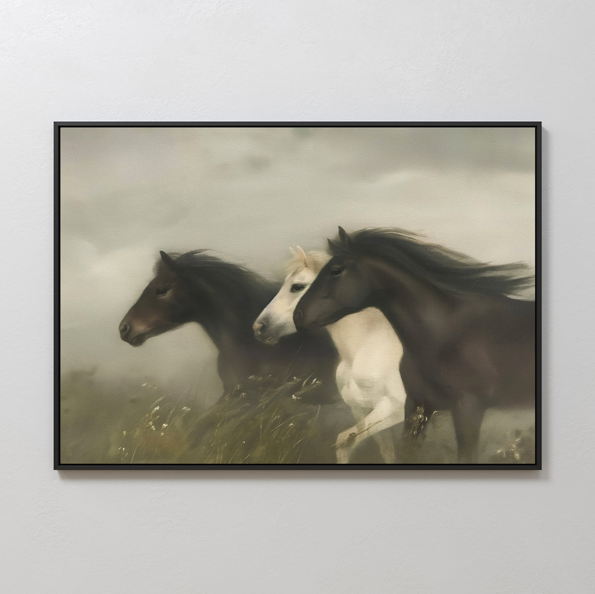 The Wild Current Canvas Art features three horses—two dark brown and one white—galloping through a misty grassy landscape, with a blurred background that enhances this minimalist wall art’s sense of movement and energy.