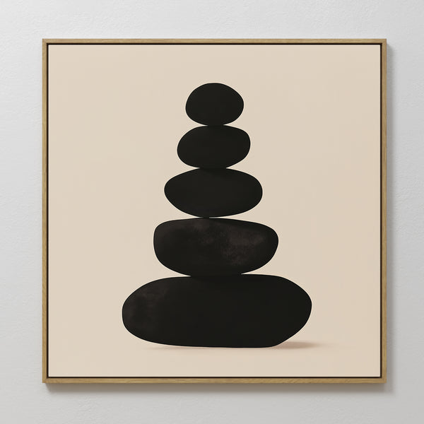 The Zen Balance Canvas Art features five black, rounded stones stacked on a light beige background and is framed in a slim gold frame—ideal as zen wall art or modern living room decor.