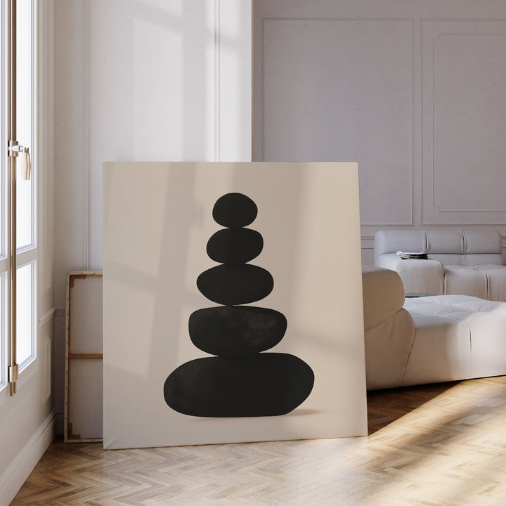 Zen Balance Canvas Art, featuring stacked black stones, is displayed in a bright living room with light wood floors and a cream sofa—a perfect choice for zen wall art or stylish decor.