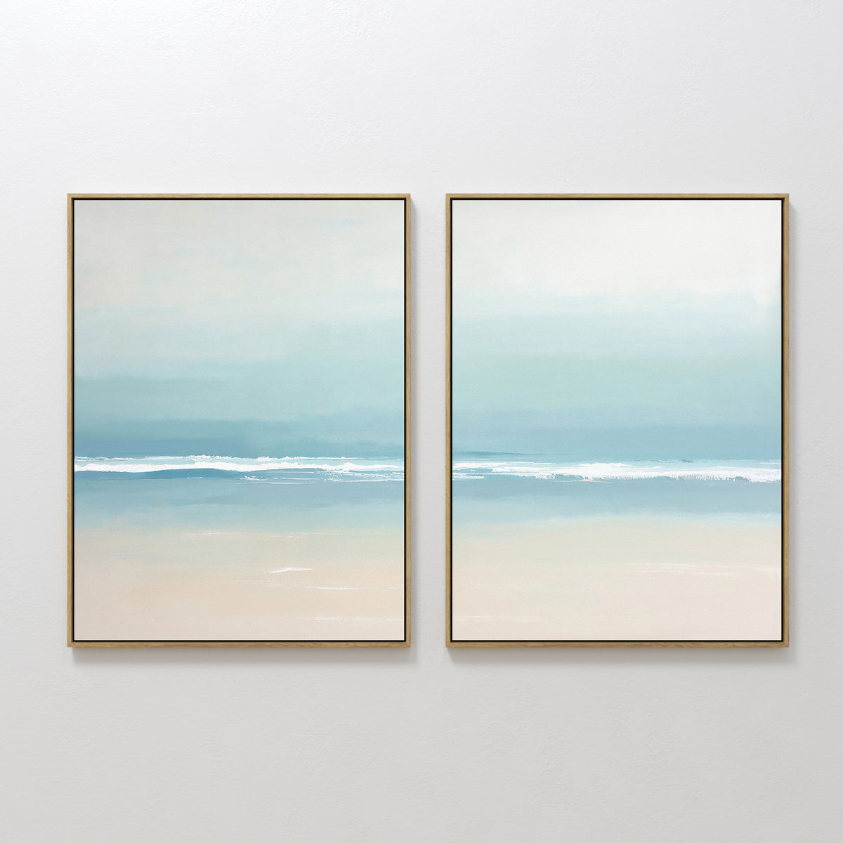 The Airy Shore - Set Of 2 features minimalist gold-framed paintings of gentle waves and a serene horizon in soft blue, teal, and beige—ideal as coastal wall art or serene seascape prints for a white wall.