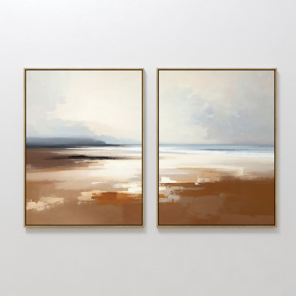The Amber Shore - Set Of 2 features framed abstract prints side by side, capturing a serene beach scene in soft beige, brown, white, and blue tones that evoke sand and sea beneath a cloudy sky.
