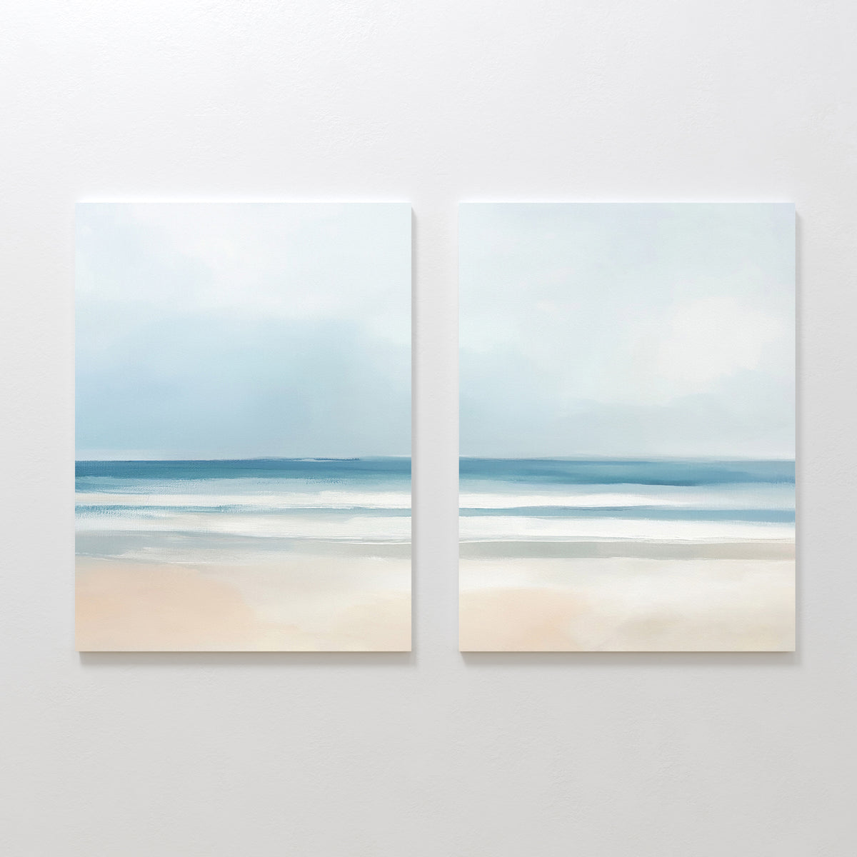 The Blurred Beach Scene - Set Of 2 features minimalist beach wall art with soft blue sky, gentle waves, and a sandy shore, displayed side by side for calming and serene decor.