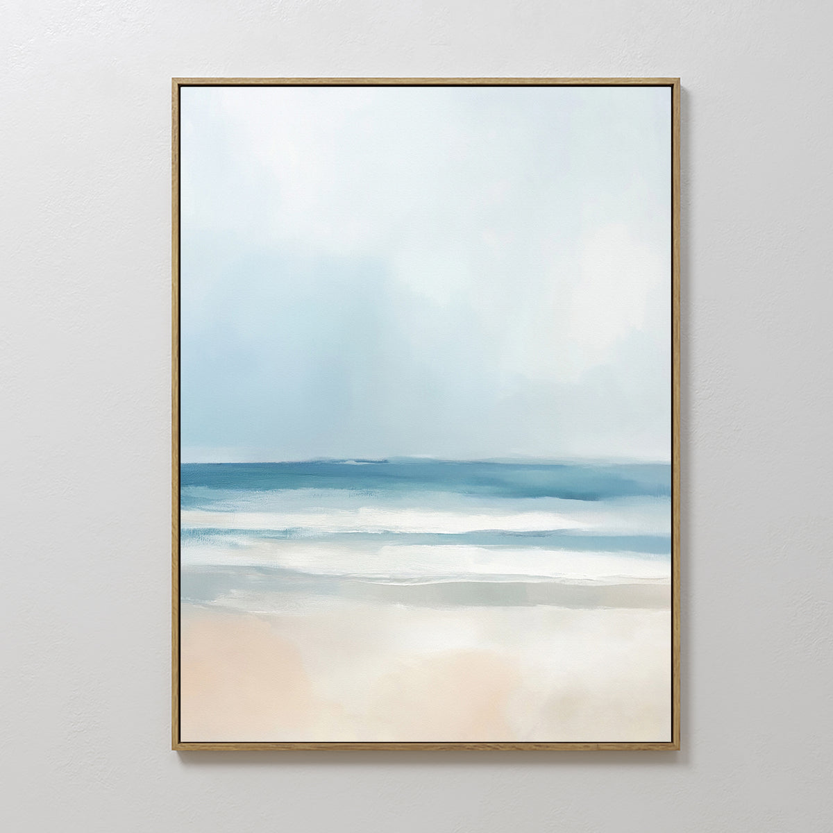 The Blurred Beach Scene Canvas Art - Vertical features a minimalist, serene coastal print with soft blue water, gentle white waves, and a light sandy shore beneath a pale, cloudy sky in an abstract style.