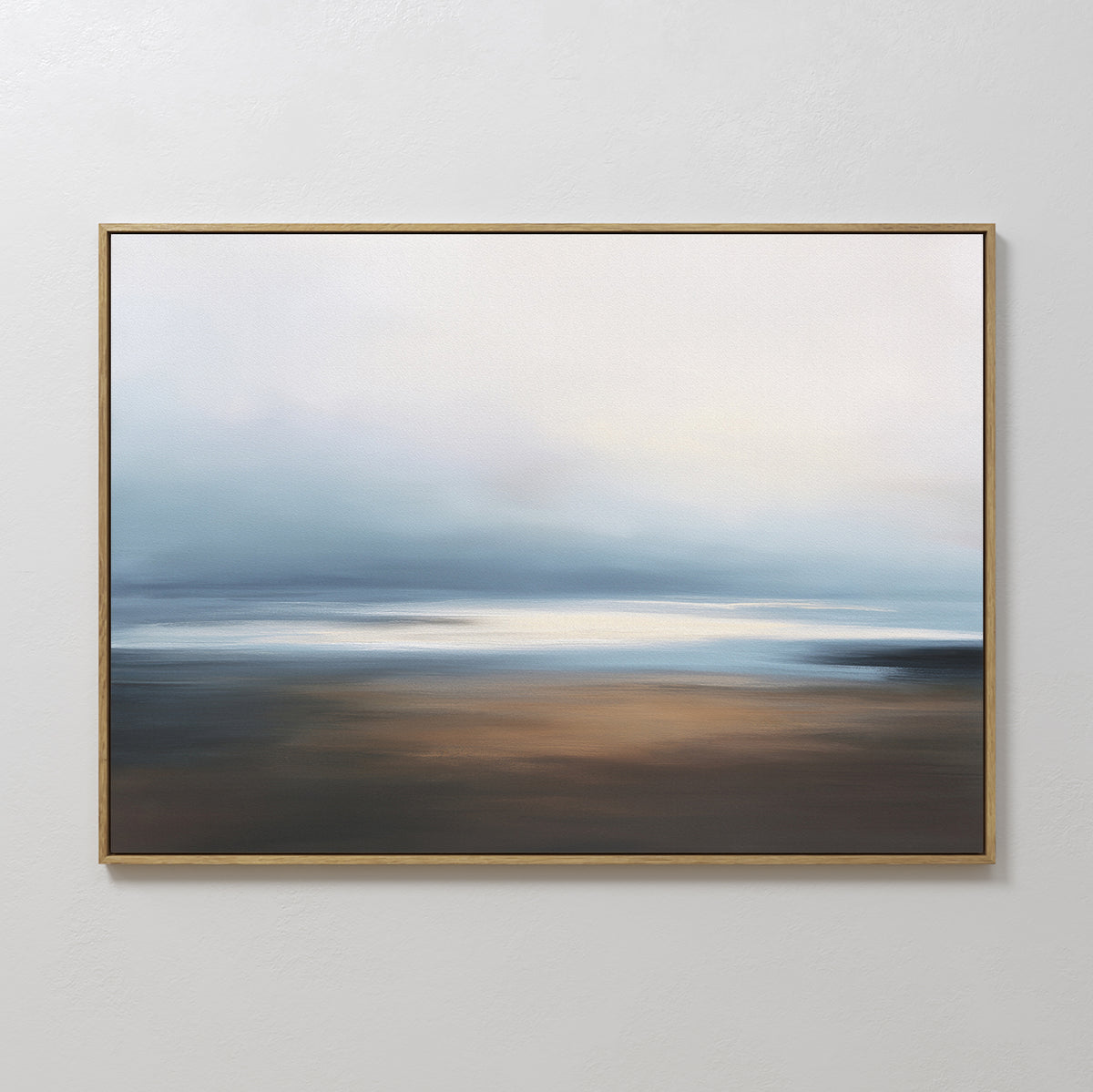 The Blurred Seascape Canvas Art - Horizontal features soft blends of blue, white, and brown, creating a dreamy coastal vibe with its gentle horizon and serene hues. This abstract wall art adds tranquility to any space when hung on a plain white wall.