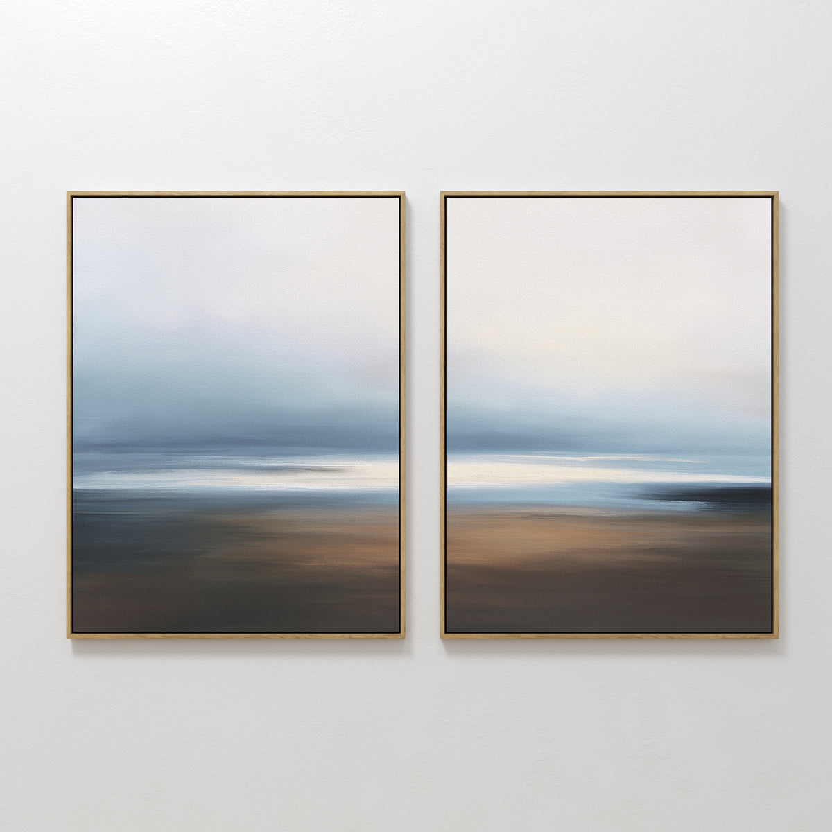Blurred Seascape - Set Of 2 features abstract framed art with soft blue, white, and brown tones, evoking a dreamy sky and horizon—ideal wall decor for adding coastal serenity to any space.
