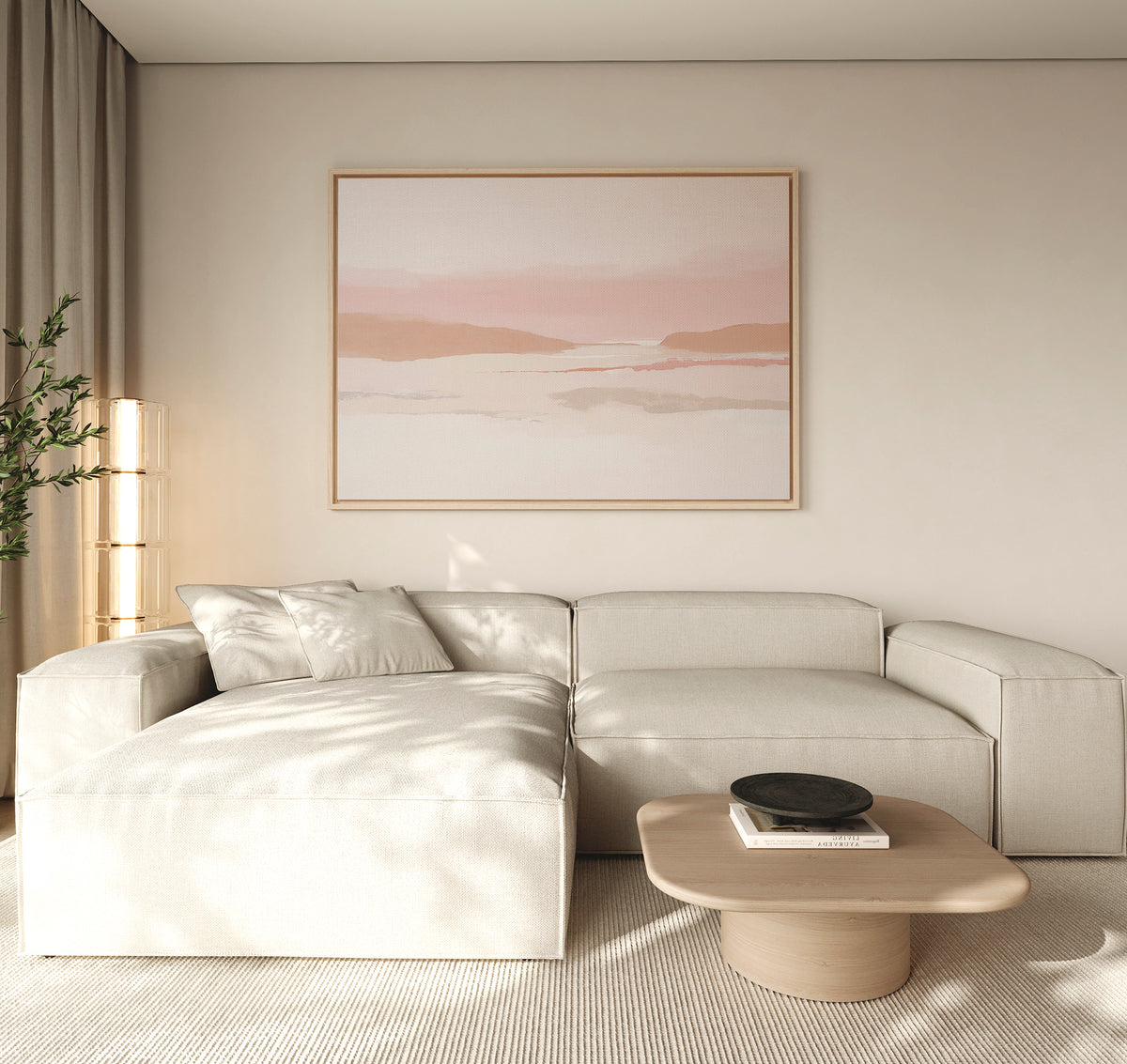 A modern living room with a light beige sectional sofa, wooden coffee table with a black bowl, tall plant, and the Blush Mesa Canvas Art - Horizontal—a serene landscape in soft pink and beige—completes the earth tone decor.