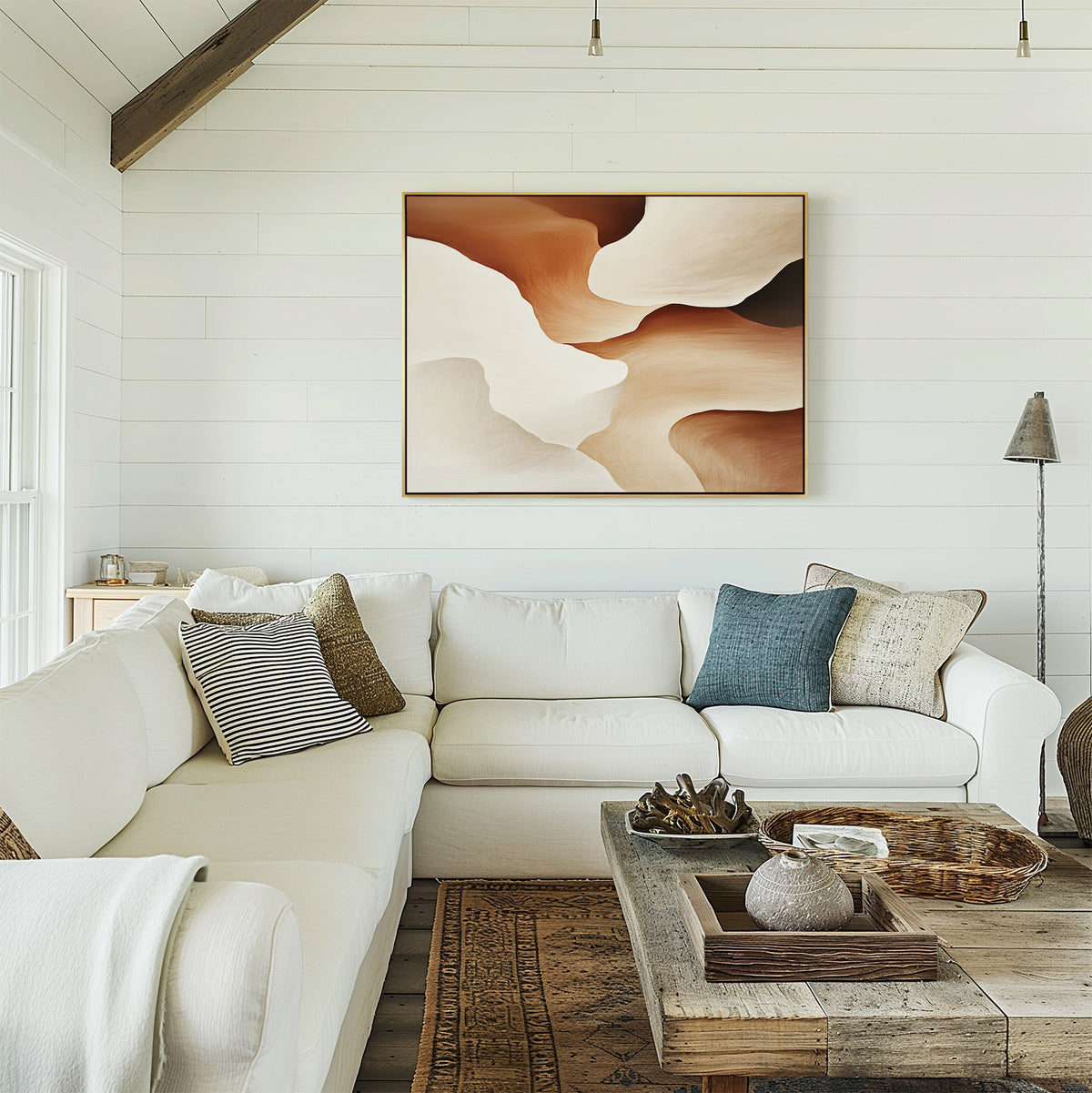 A bright, cozy living room with a white sectional sofa, assorted pillows, a rustic wooden coffee table, and the Canyon Curves Canvas Art - Horizontal in warm earth tones on a shiplap-paneled wall.