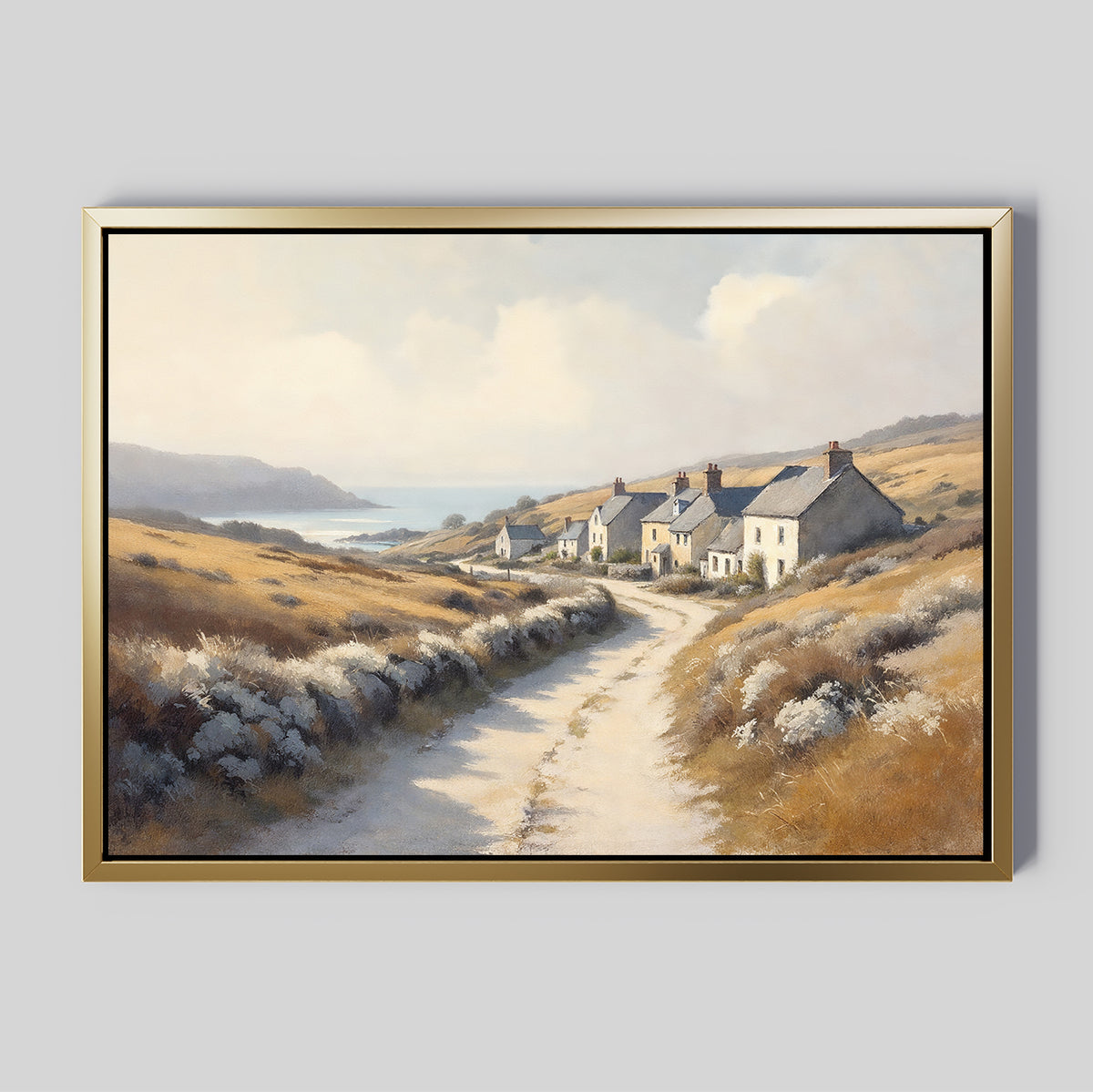The Coastal Haven Canvas Art - Horizontal features a framed rustic landscape with a winding dirt road, cottages, rolling hills, and the sea beneath a partly cloudy sky.