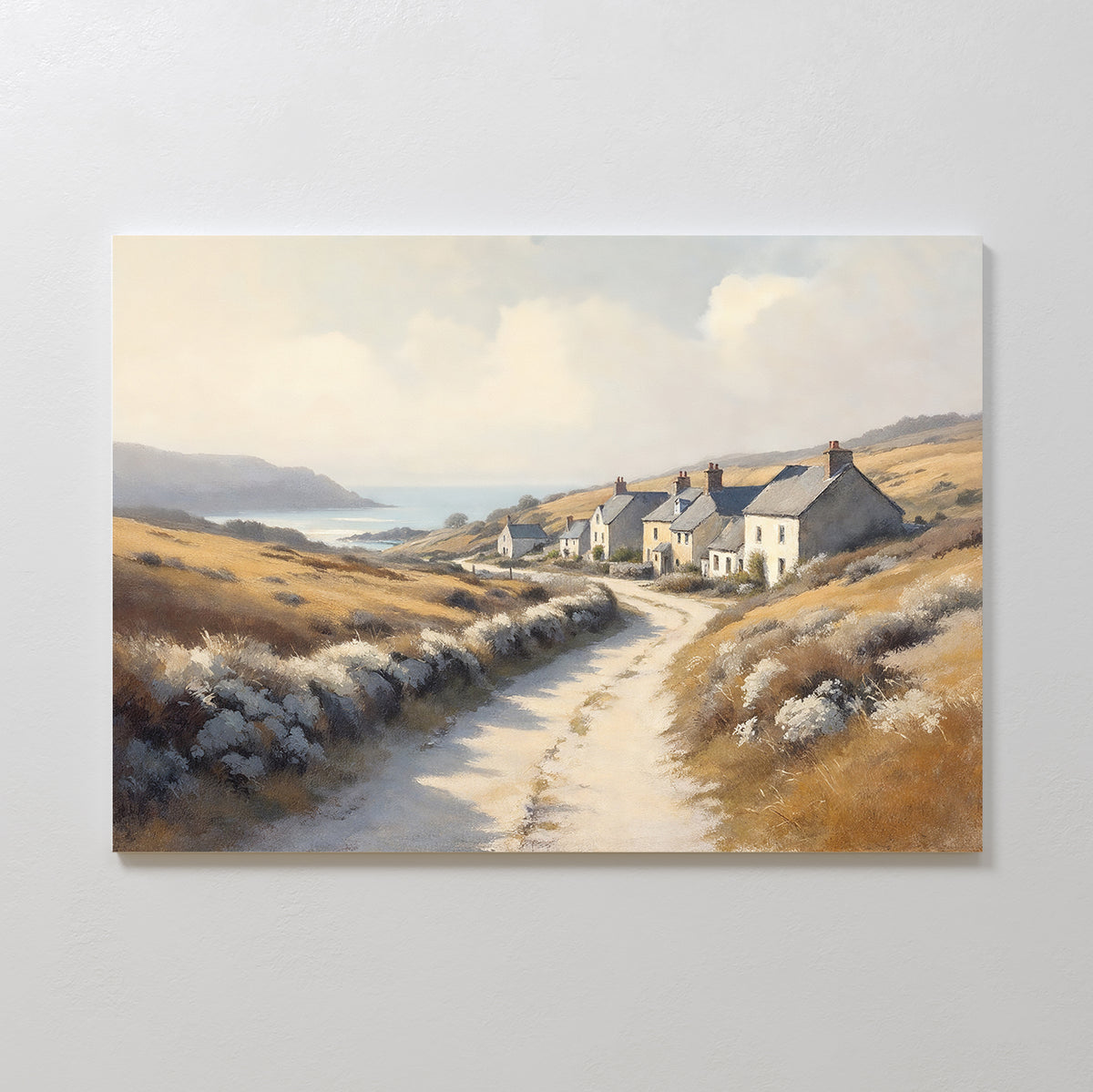 Bring serene charm to your space with the Coastal Haven Canvas Art - Horizontal, featuring a quiet country road winding past cottages and golden fields toward a distant blue sea under a soft sky—a perfect rustic landscape.