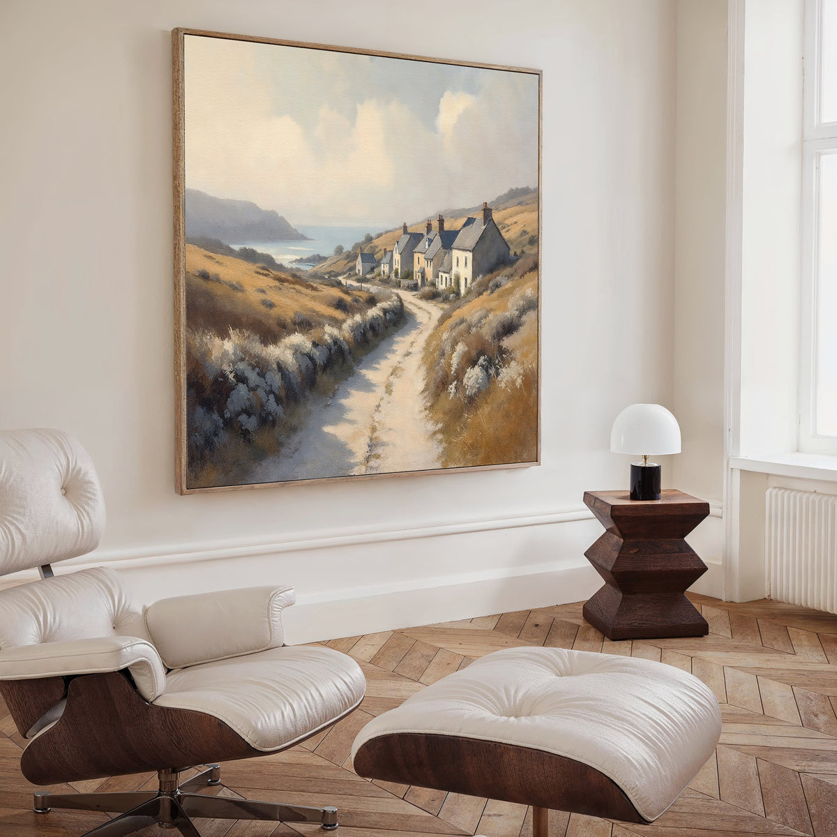 A modern living room with a white lounge chair and ottoman, wooden side table with a small white lamp, and the Coastal Haven Canvas Art - Square hanging on the wall.