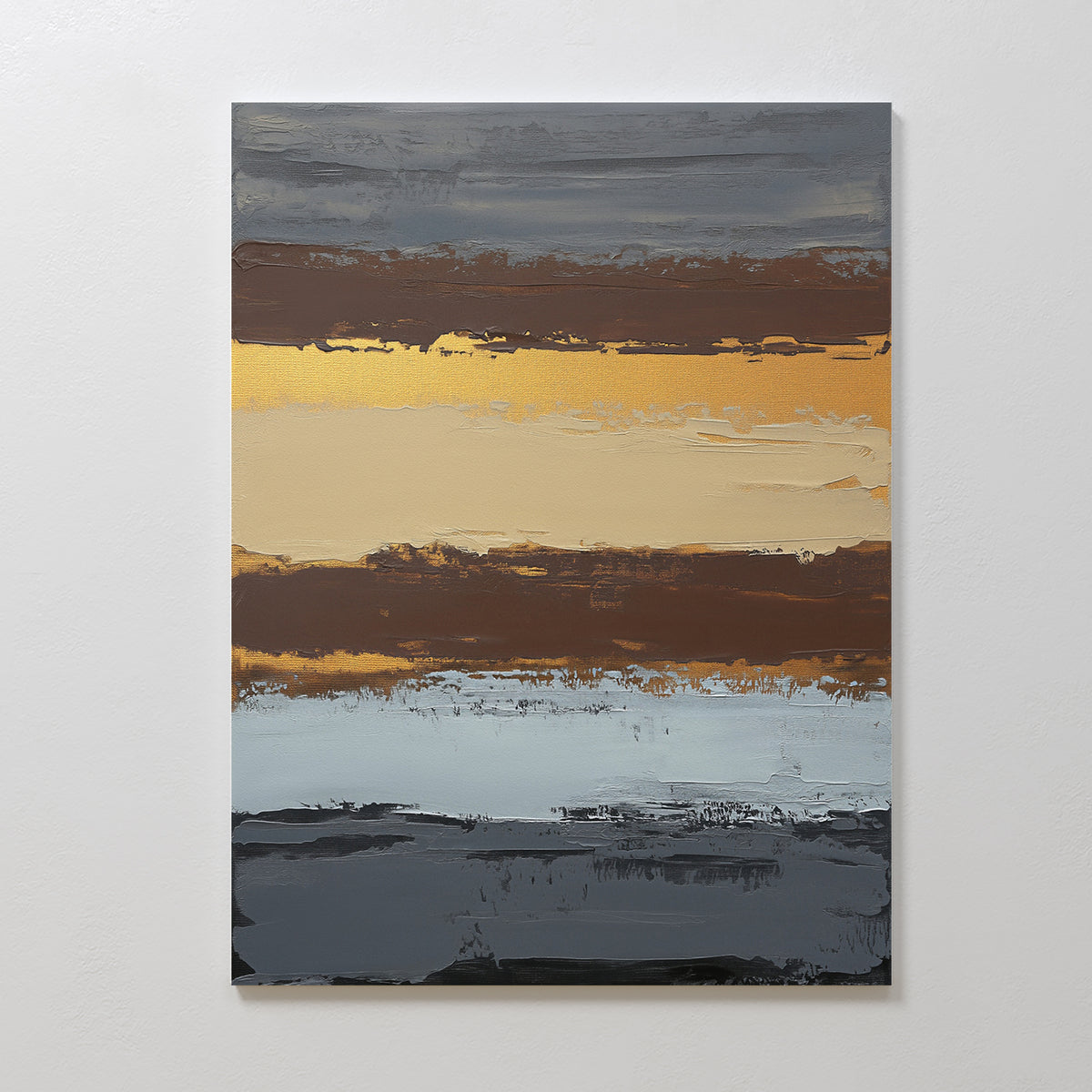 Coastal Strata Canvas Art - Vertical features abstract bands of dark gray, gold, tan, brown, and light blue. This artwork brings earthy sophistication to any space and resembles a layered landscape or sunset against a white wall.