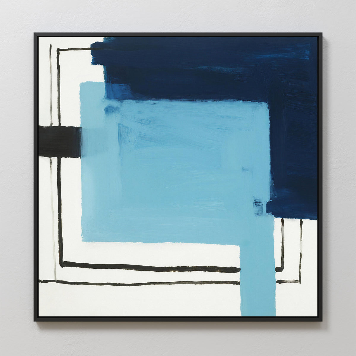 The Cobalt Intersection Canvas Art - Square showcases overlapping blue and black rectangles on white, accented by bold brushstrokes and thin black lines, all presented in a sleek black frame.