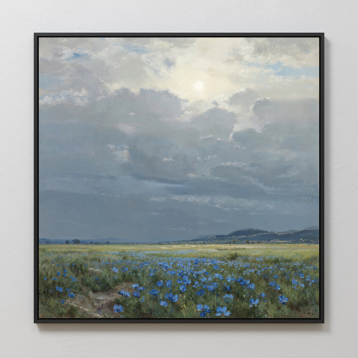 Cornflower Fields Canvas Art - Square: A framed landscape canvas print featuring a grassy field with blue wildflowers and distant hills under a cloudy, sunlit sky. Perfect countryside wall art for any space.