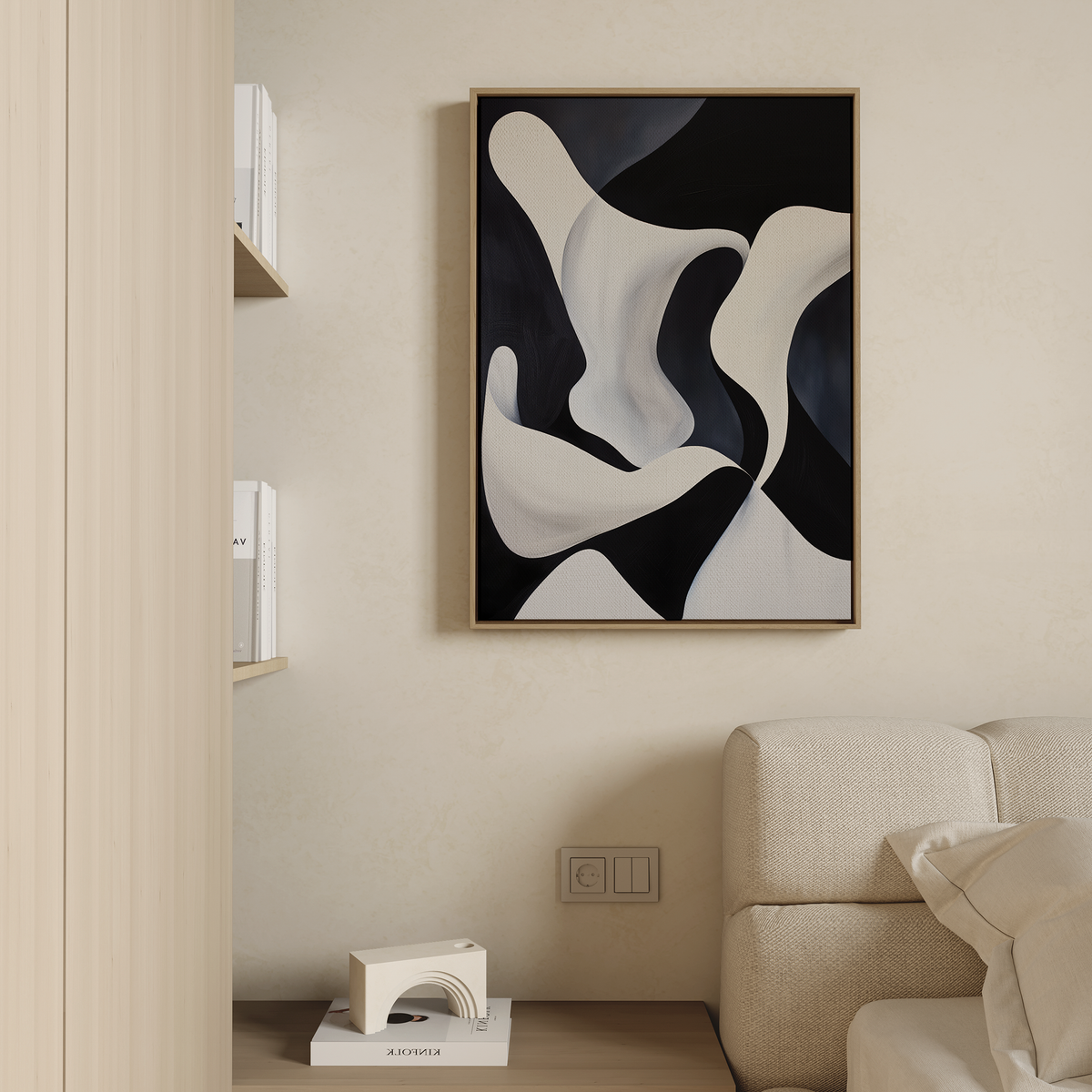 A modern living room features a beige sofa, neutral walls, and a wooden shelf with books. Above the sofa hangs the Deep Blue Calm Abstract Canvas Art in a wooden frame, adding to the minimalist decor.
