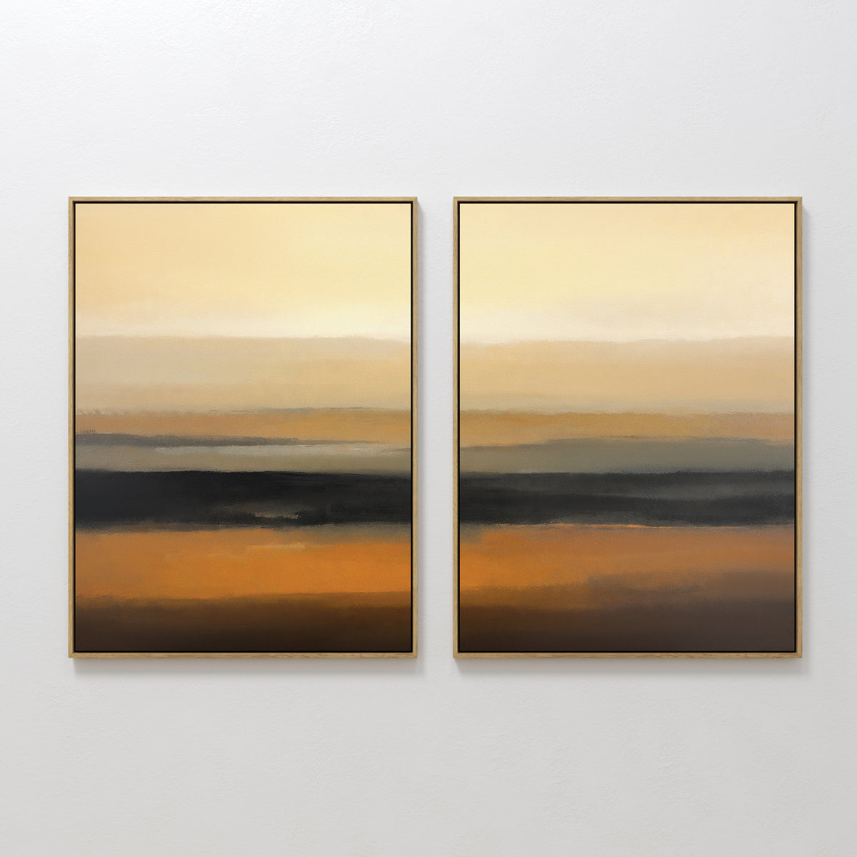 Desert Mirage - Set Of 2 features framed abstract prints with horizontal layers of gold, orange, brown, and black. The earthy tones blend seamlessly to create a serene gradient effect inspired by desert landscapes.