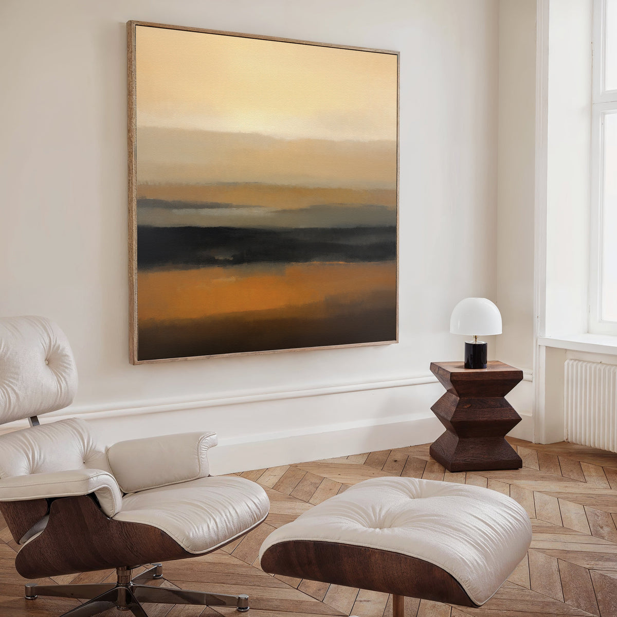 A modern living room with a white lounge chair and ottoman, wooden side table, white lamp, and the Desert Mirage Canvas Art - Square in warm earth tones on the wall. Natural light from the window creates Nordic Park-inspired serenity.