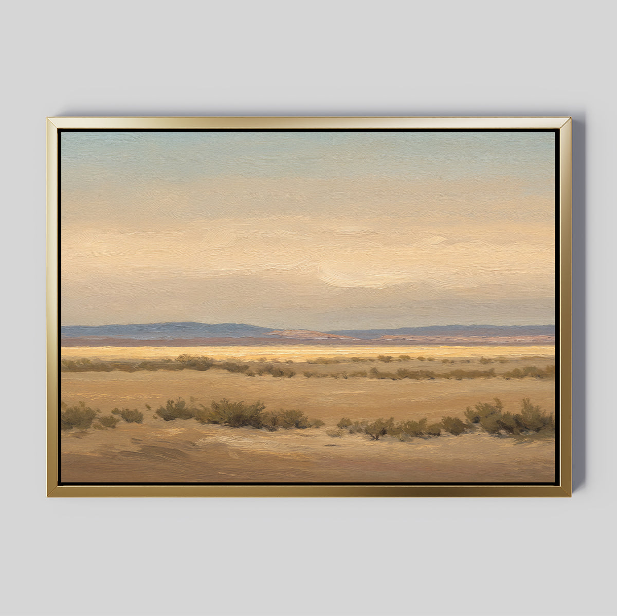 Desert Solitude Canvas Art - Horizontal features a serene desert landscape with sparse bushes, wide plains, distant mountains, and a soft cloudy sky—ideal as tranquil wall decor against a plain gray background.