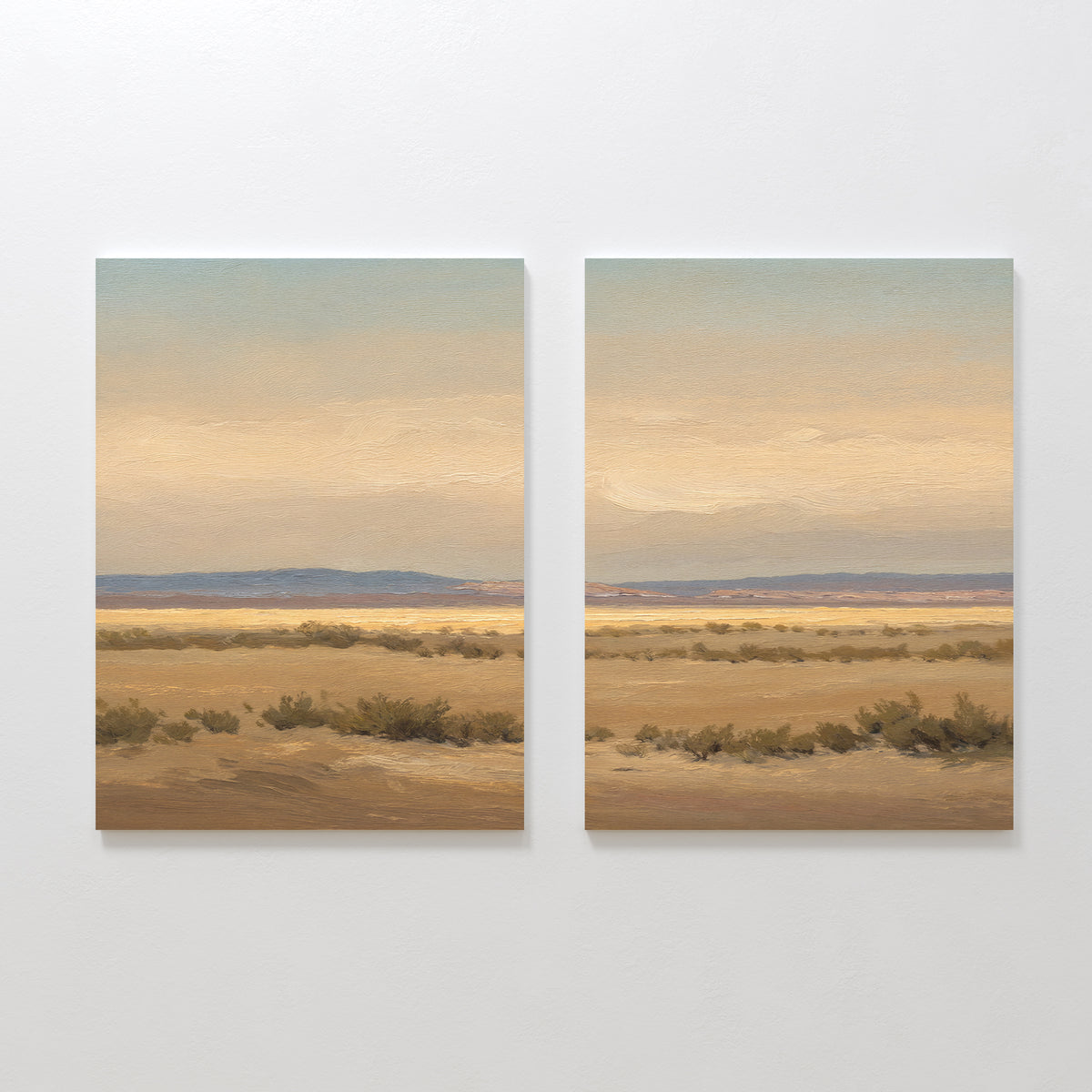 Desert Solitude - Set of 2 features two canvas paintings depicting a serene southwestern landscape in beige, brown, and blue hues with dry grass and distant hills, ideal as calming wall decor.