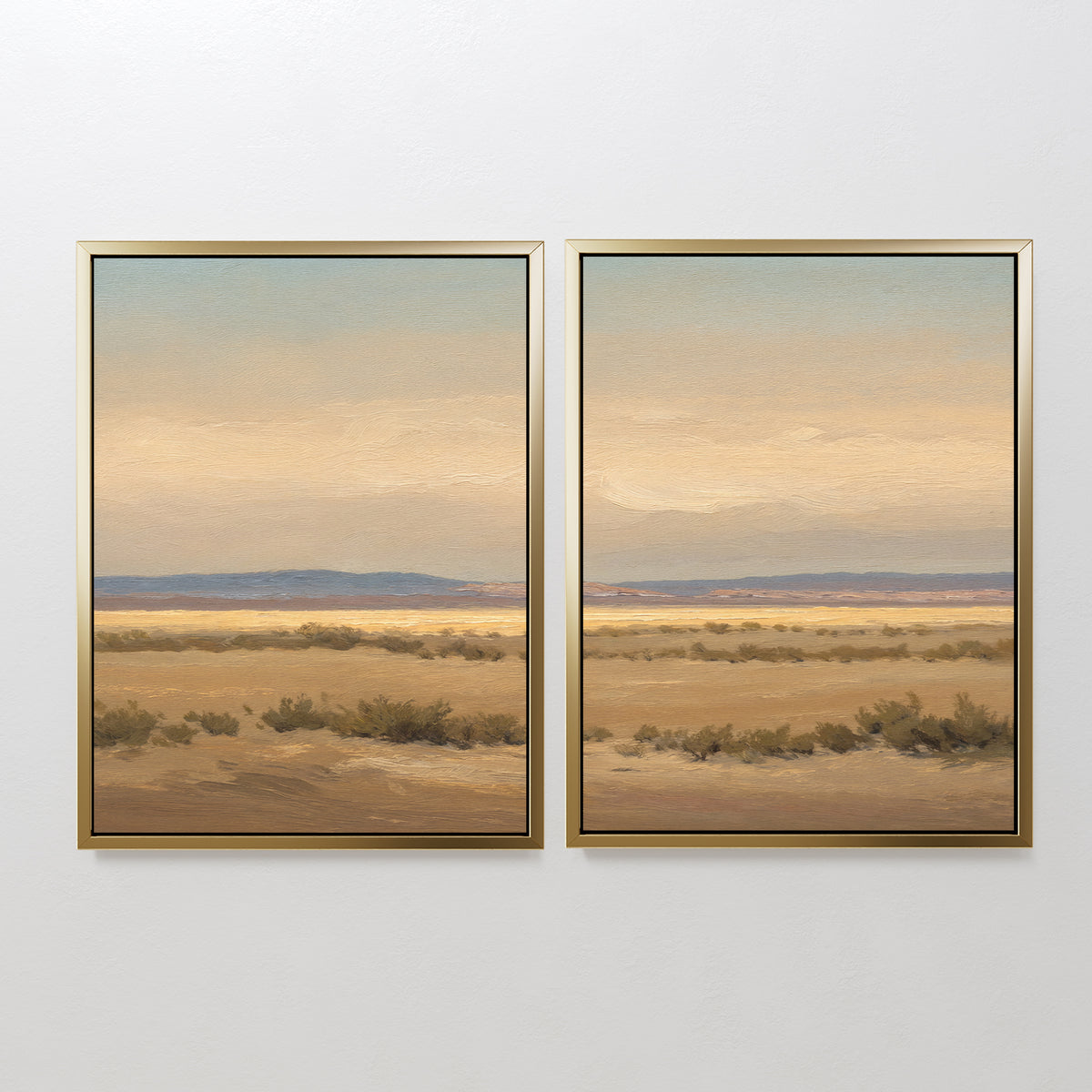 Desert Solitude - Set of 2 features southwestern landscape art with dry grass, distant hills, and a cloudy sky in earth tones, creating serene wall decor on a plain white wall.