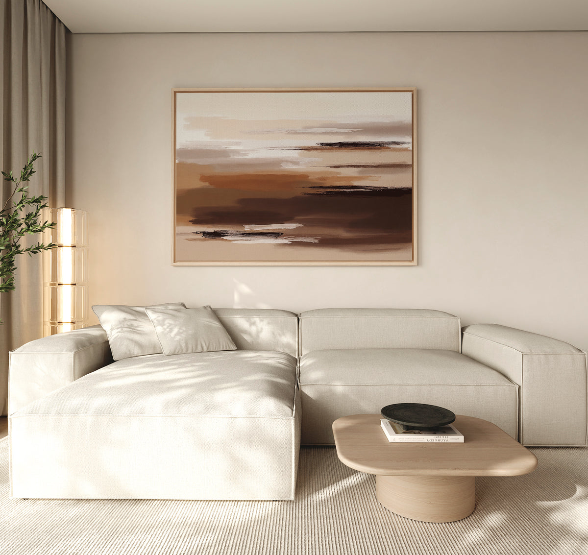 A modern living room with a beige sectional sofa, light wood coffee table, decorative bowl, tall plant, and the Desert Winds Canvas Art - Horizontal on the wall. Natural light fills the space.