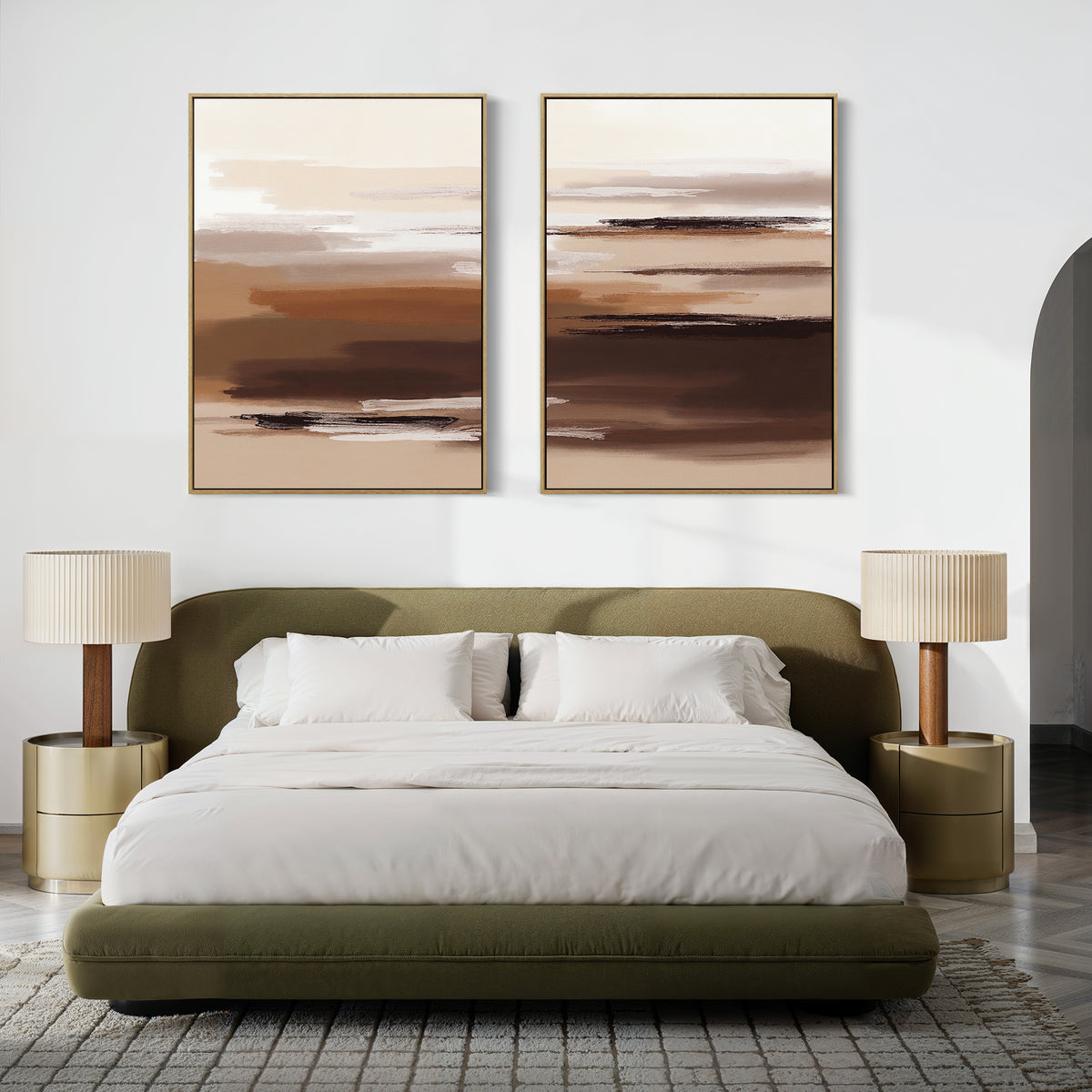 Modern bedroom with an olive green upholstered bed, crisp white bedding, two round gold nightstands, pleated beige lamps, and the Desert Winds - Set Of 2 earth-tone abstract prints in brown and beige hanging above the bed.