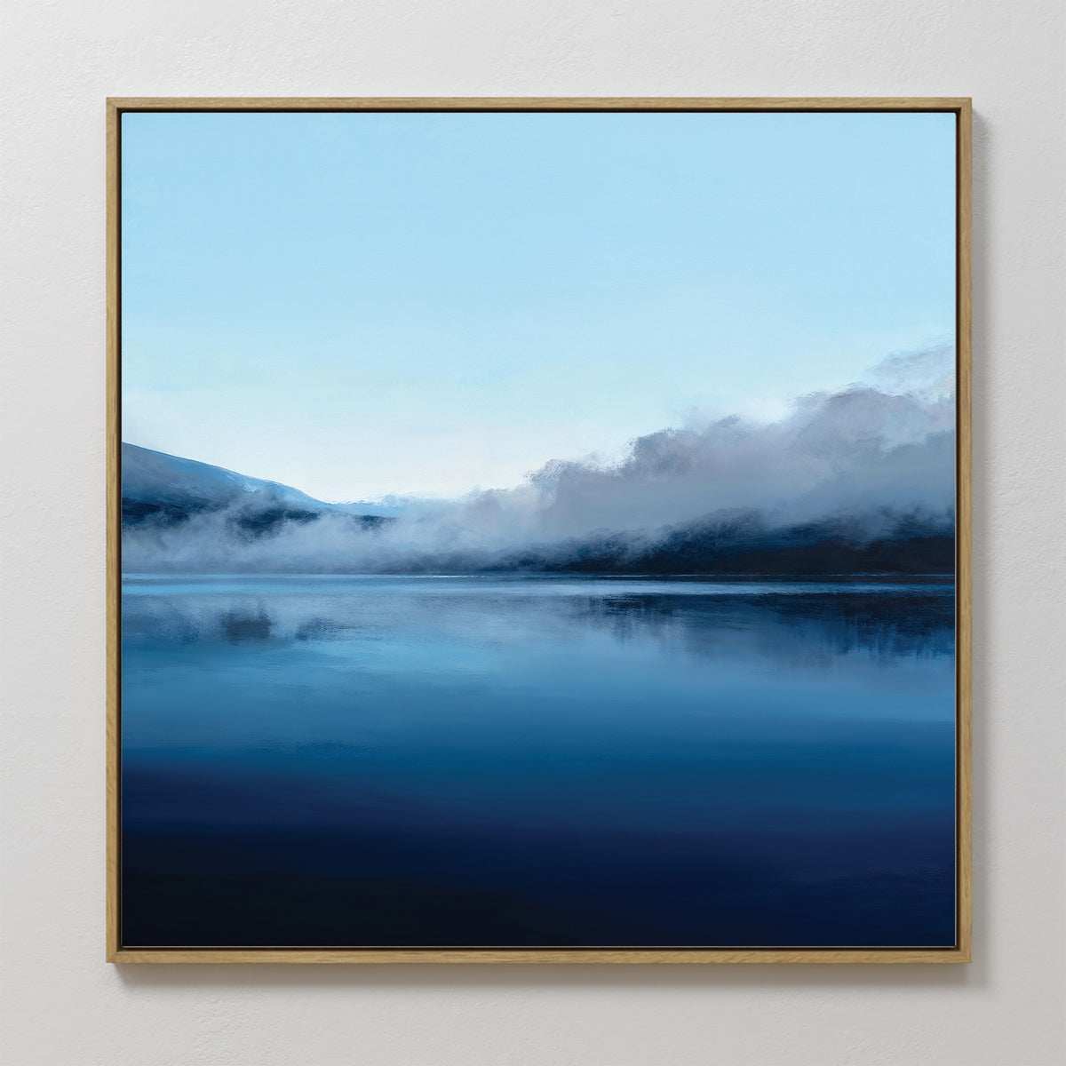 The Fjord Mist Canvas Art - Square features a serene blue lake with misty mountains and soft clouds, perfect Nordic wall art to bring tranquility to any bedroom decor.