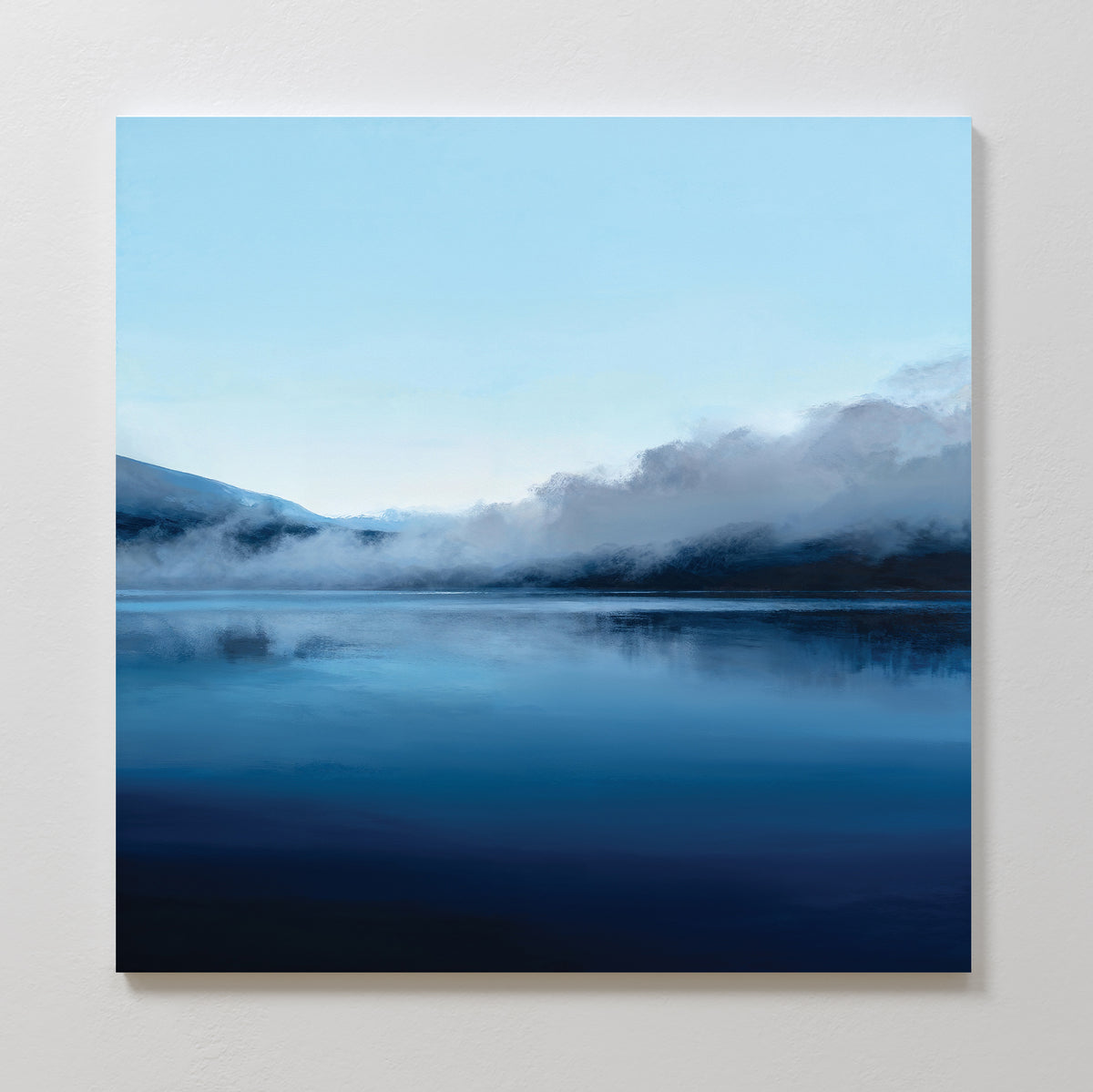 Bring peaceful reflections and tranquil style to your space with Fjord Mist Canvas Art - Square, featuring a serene lake and misty mountains beneath a clear blue sky—ideal Nordic wall art for calming bedroom decor.