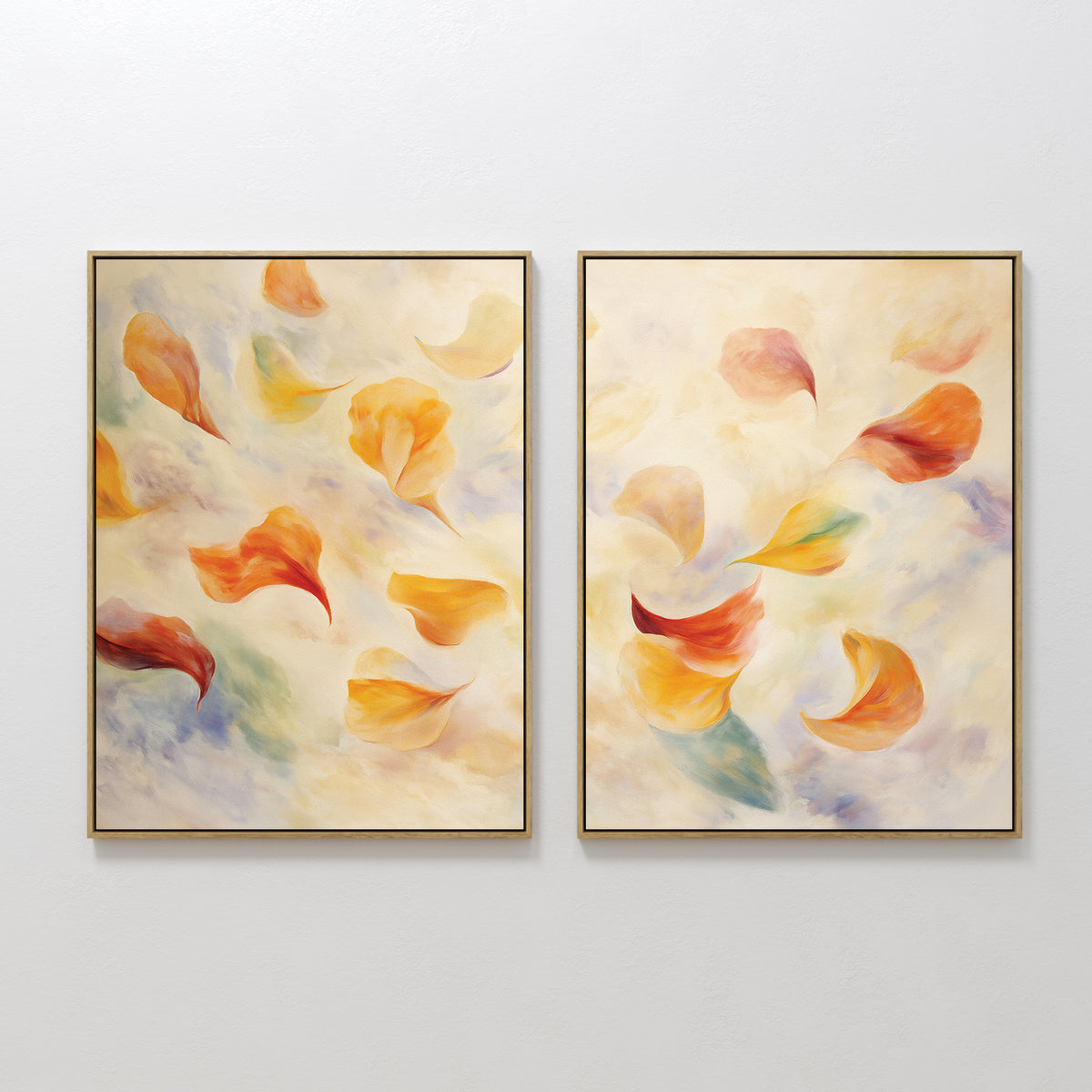 The Floating Petals - Set of 2 features framed canvas prints with soft, swirling shapes in warm orange, yellow, and red tones, evoking petals on a cloud-like backdrop. Display them side by side for organic elegance on any wall.