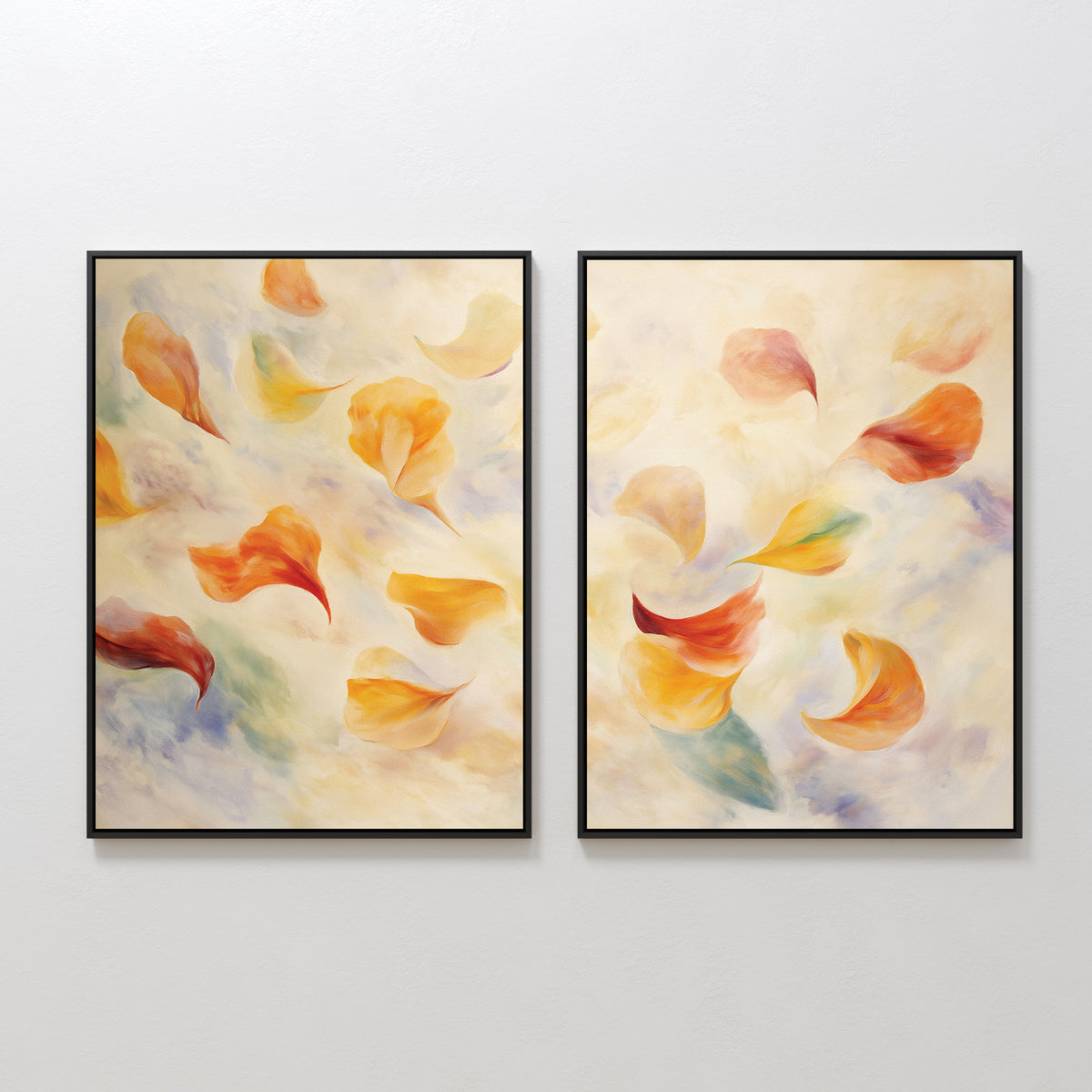 The Floating Petals - Set of 2 features framed abstract paintings with swirling, colorful leaf-like shapes and floating petals in warm orange, yellow, and red tones set against a soft light background.
