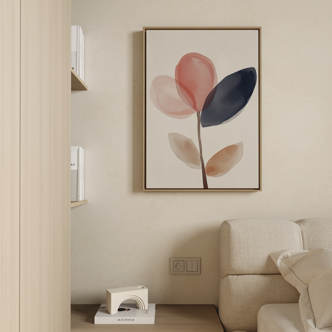 A minimalist living room featuring a beige couch and the Petal Breeze Canvas Art—abstract red, navy, and beige leaves—on the wall, with wooden shelves of books and a small white floor lamp for stylish decor.