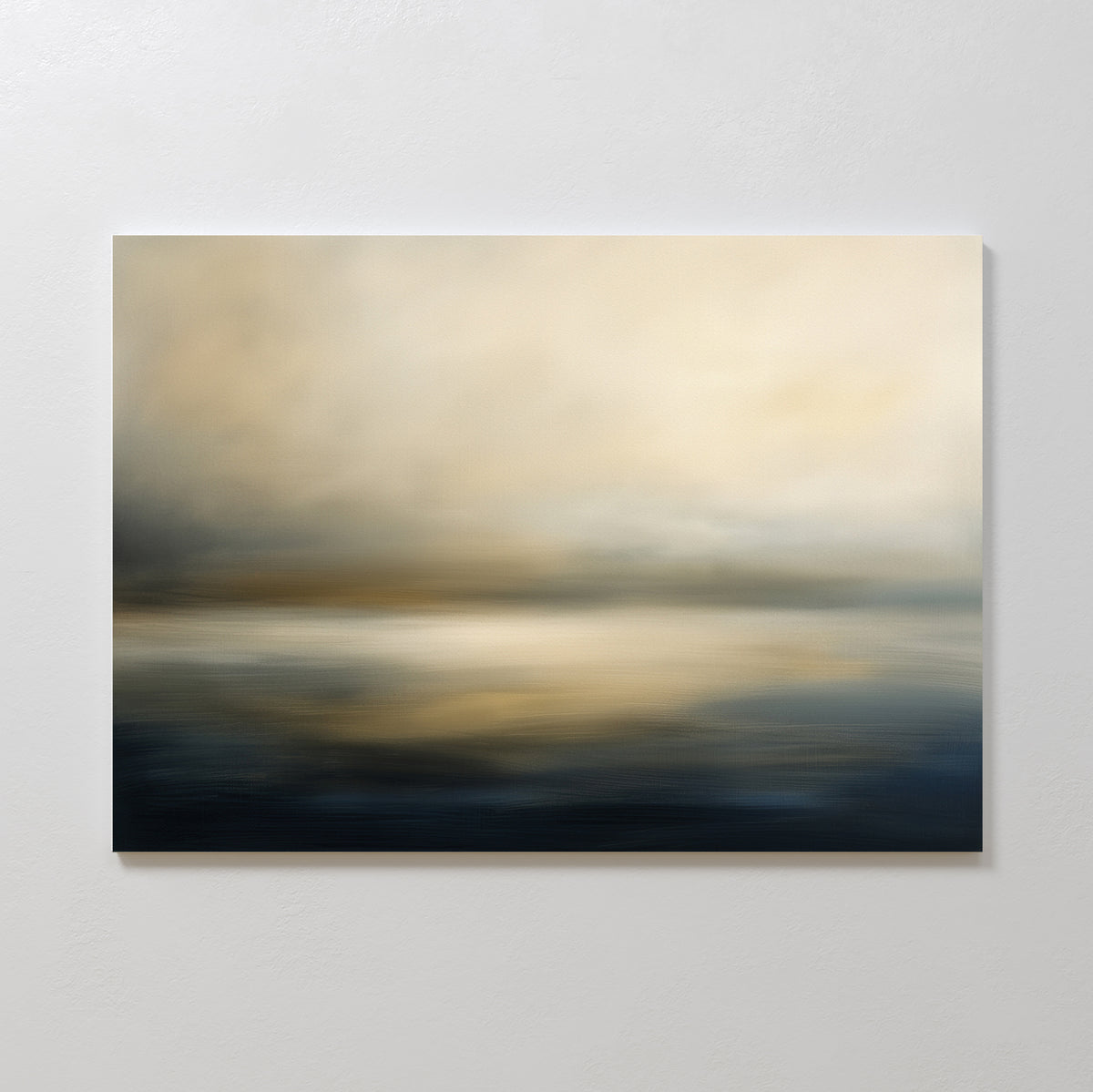 The Foggy Bay Impressions Canvas Art - Horizontal features soft, blurred tones of beige, gold, and dark blue that evoke a tranquil water and sky landscape—ideal for creating serene decor on a light gray wall.