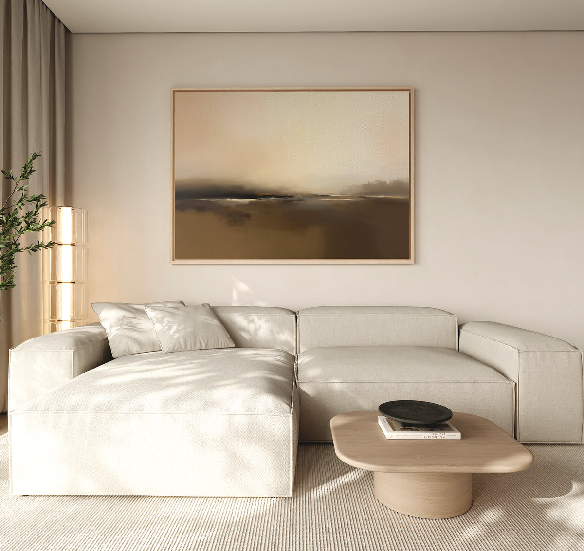 A modern living room with a cream sectional, light wood coffee table, black bowl, floor lamp, potted plant, and the Foggy Beach Expanse Canvas Art - Horizontal adding serene, neutral tones to the beige wall.