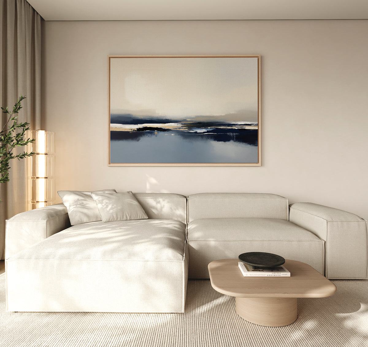 A modern living room features a light beige sectional, wooden coffee table, black decorative bowl, tall corner plant, and the Frozen Bay Canvas Art - Horizontal on the wall. Neutral tones and minimalist decor define this inviting space.