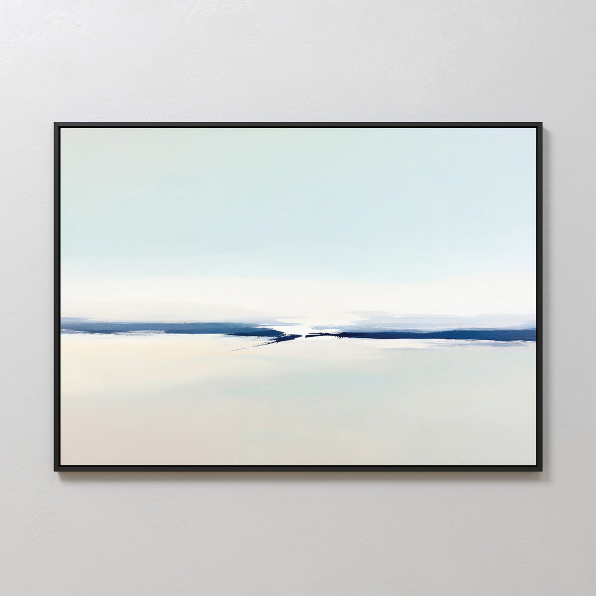 The Frozen Channel Canvas Art - Horizontal features minimalist brushstrokes in soft blue, white, and beige with a subtle horizon line. Framed in black and displayed on a light gray wall, it’s ideal for modern living room decor.