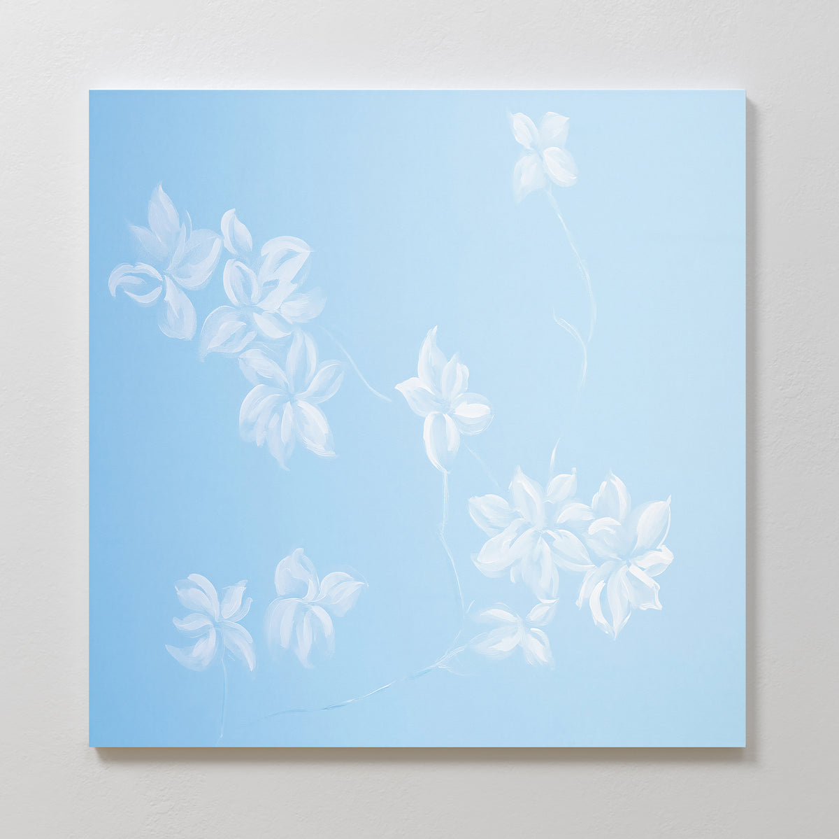 Add a touch of elegance to your space with the Gentle Blossoms Canvas Art - Square: a minimalist white floral painting with delicate flowers and faint stems on a light blue background, perfect as wall art for any room.