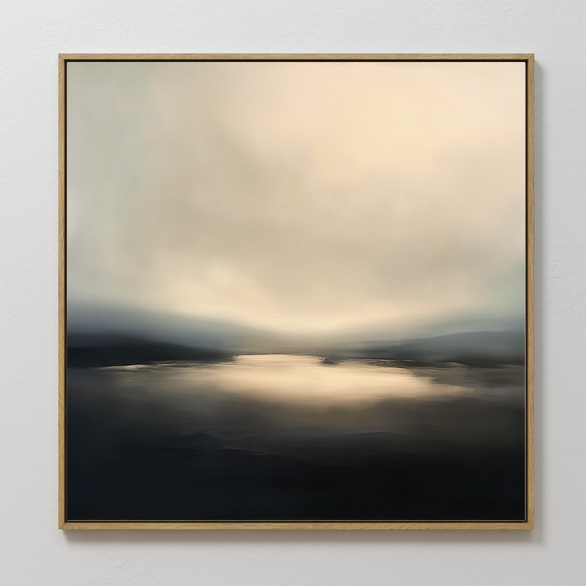 The Golden Fog Horizon Canvas Art - Square features a framed abstract landscape with soft, blurred tones of pale gold, gray, and black, evoking light on water under a misty sky in a serene coastal style.
