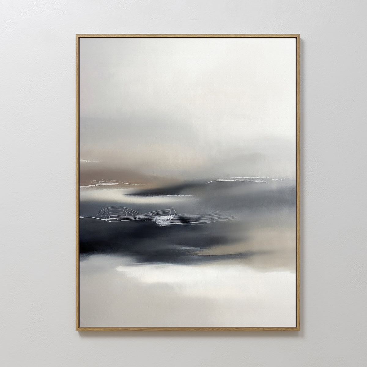 The Grey Ripples Canvas Art - Vertical features abstract gradients of white, gray, and black with beige accents and faint lines. Framed in a slim gold frame, it’s perfect for modern living rooms displayed on a white wall.