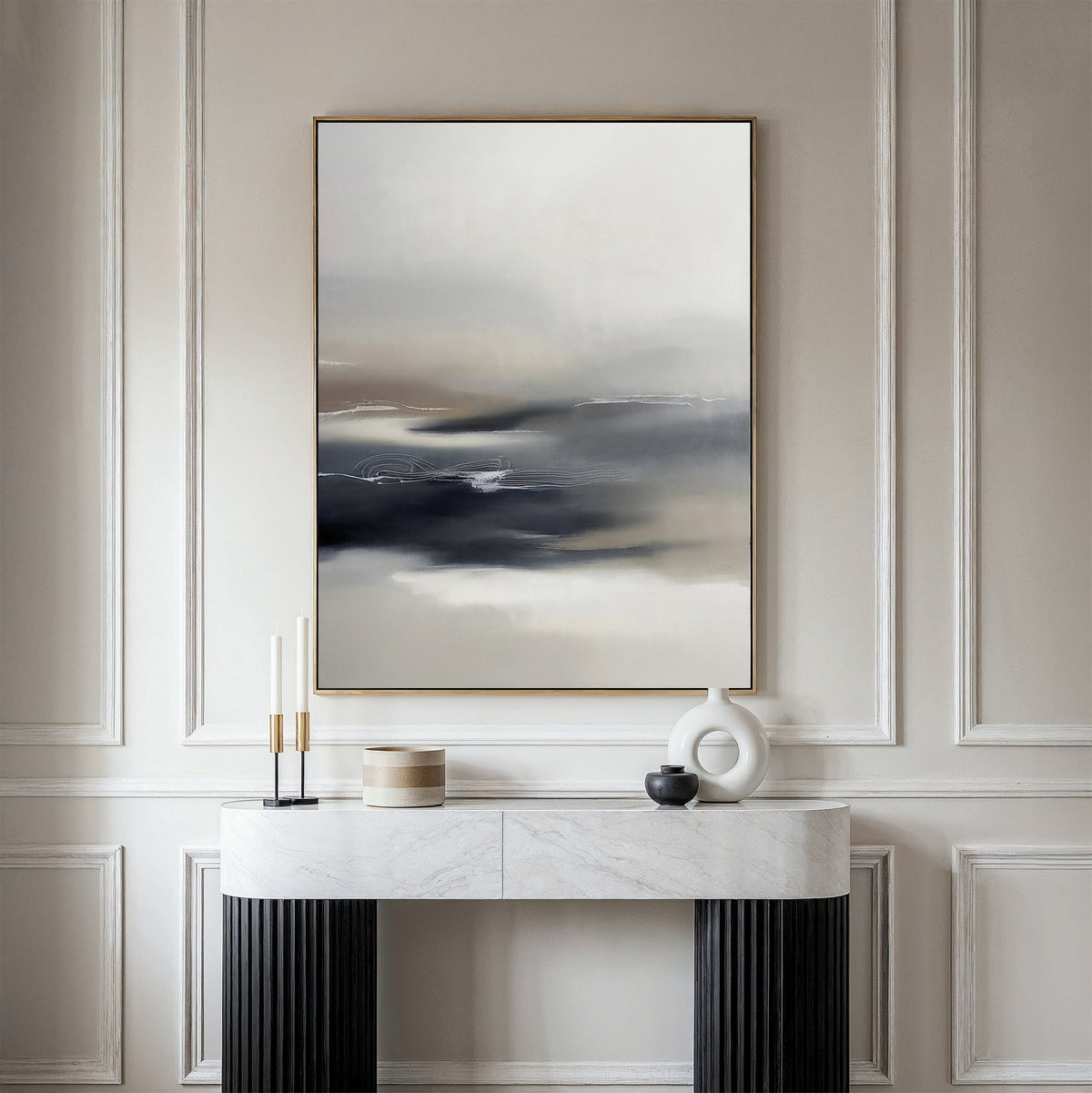 A minimalist console table with a marble top displays modern decor, while the Grey Ripples Canvas Art - Vertical hangs above on an elegant paneled wall—creating a perfect focal point for contemporary living rooms.