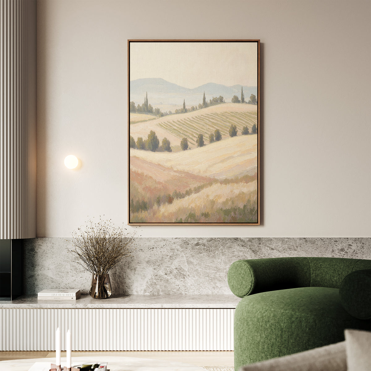 A modern living room with a green armchair, marble accents, a vase with dried branches, and the Harvest Fields Canvas Art - Vertical adds serene decor inspired by rolling hills and trees to the space.