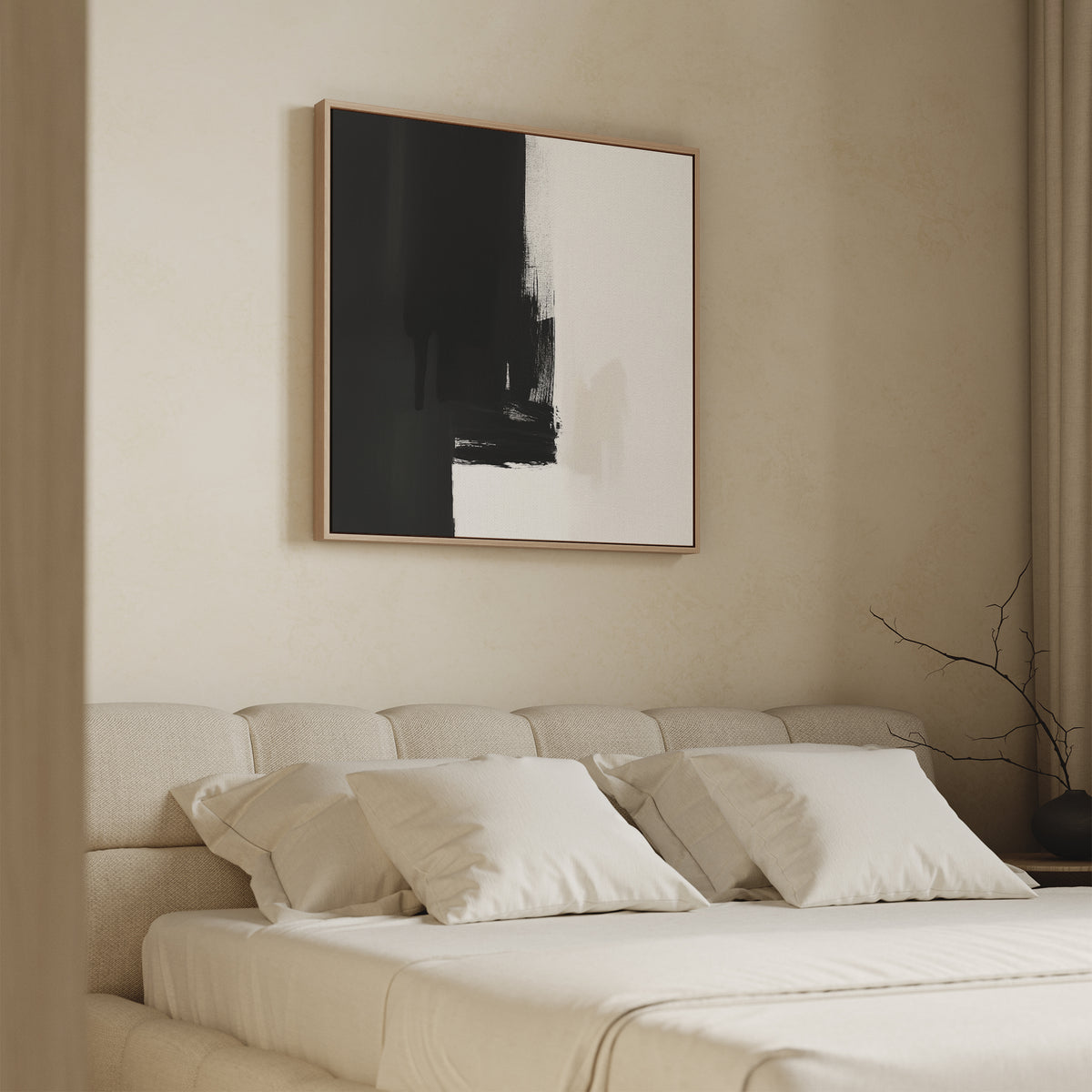 A minimalist bedroom with a beige upholstered bed, white bedding, and the Ink Divide Canvas Art - Square above the headboard. A bare branch in a vase rests on a side table.