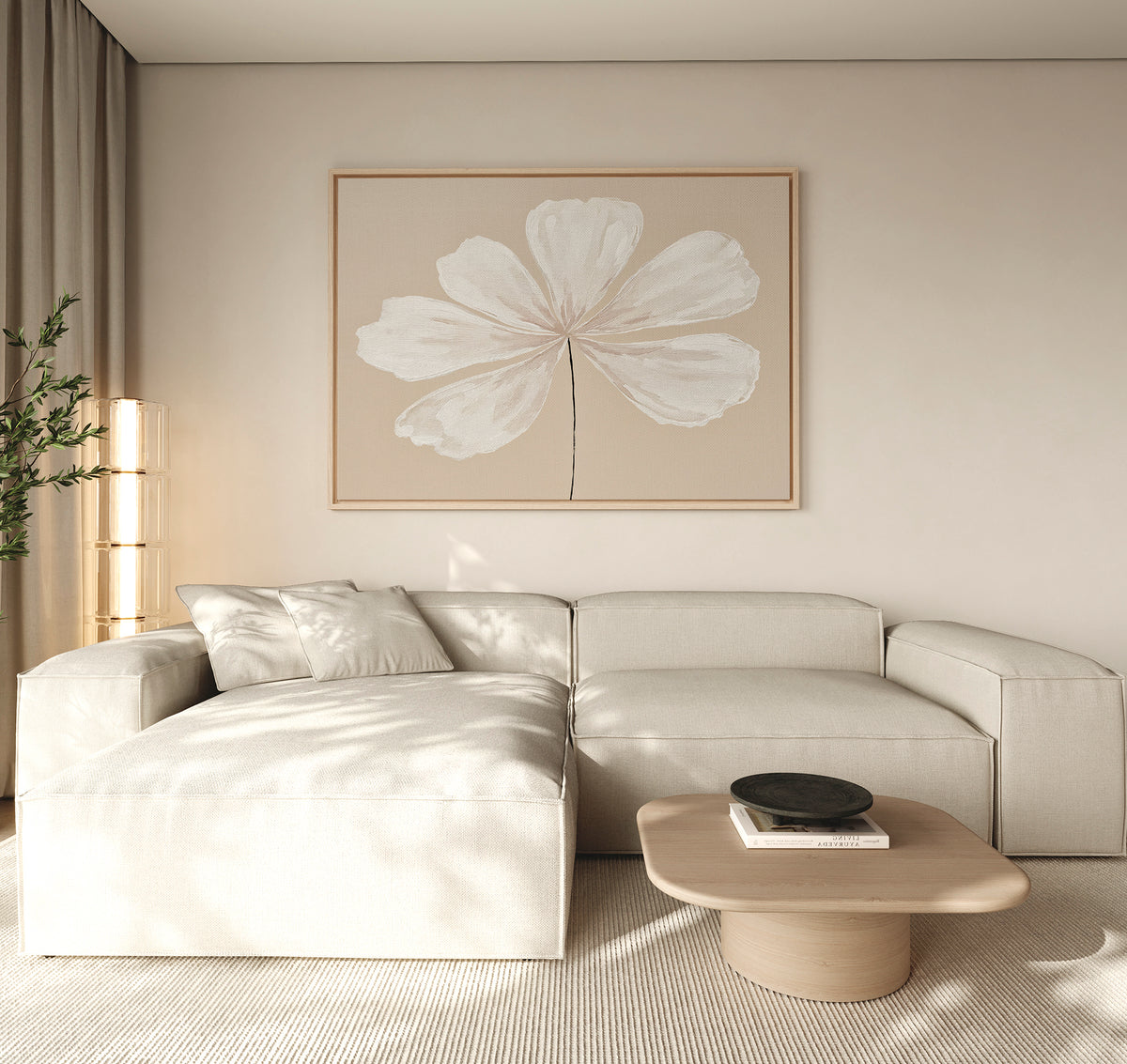 A modern living room with a light beige sectional sofa, minimalist light wood coffee table with a black bowl, neutral rug, tall plant, and the Ivory Bloom Canvas Art - Horizontal as neutral wall decor above the seating area.